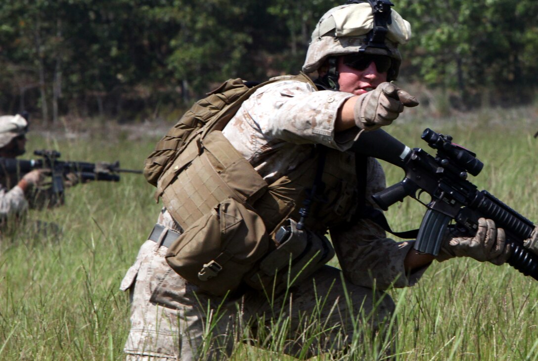 Cpl. Anson Walck, fire team leader, 1st platoon, Company F, Anti-Terrorism Battalion, attached to 2nd Marine Division, yells for his Marines to push forward during the squad based support by fire assault course, aboard Marine Corps Base Camp Lejeune, N.C., Sept. 15. The course was part of a training exercise in which the platoons cycled through events such as the assault course, an offensive attack and holding a defensive position.