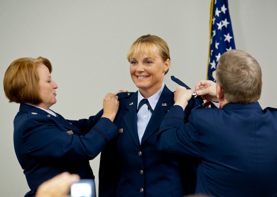 Newly promoted Col. Toni Wilkins, a 919th Medical Squadron nurse practitioner, gets her eagles pinned on Sept. 11 at Duke Field, Fla. Doing the honors are Lt. Col. Susan Eschete, the squadron's chief nurse, and Col. (Dr.) Edward Seeliger, commander of the 919th MDS.  (U.S. Air Force photo/Tech. Sgt. Samuel King Jr.)