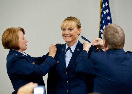 Newly promoted Col. Toni Wilkins, a 919th Medical Squadron nurse practitioner, gets her eagles pinned on Sept. 11 at Duke Field, Fla. Doing the honors are Lt. Col. Susan Eschete, the squadron's chief nurse, and Col. (Dr.) Edward Seeliger, commander of the 919th MDS.  (U.S. Air Force photo/Tech. Sgt. Samuel King Jr.)