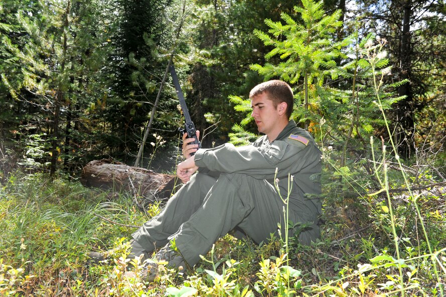 Staff Sgt. Kevin Matthew, 92nd Air Refueling Squadron boom operator from Fairchild Air Force Base, Wash., prepares to establish initial communication after egressing out out of a simulated plane crash during the on-scene commmander exercise Sept. 1, 2011, in Ione, Wash. (U.S. Air Force Photo/Tech Sgt. J.T. May III)