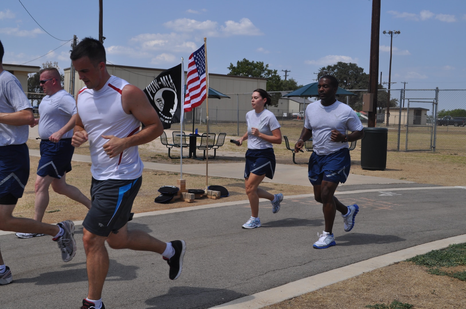 Members of the 33rd Network Warfare Squadron and the 26th Network Operations Group kept the baton moving for their part of the 24-hour POW/MIA Vigil Run at the Gillum Fitness Center track, Lackland Air Force Base, Texas, Sept. 15. Volunteers also read aloud the names of American military members listed as prisoners of war or missing in action. Other 24th Air Force units that took part in the run included Headquarters 24th Air Force, the 346th Training Squadron, the 624th Operations Center, the 90th Information Operations Squadron, and the 690th Information Operations Squadron. (U.S. Air Force photo by Tech. Sgt. Scott McNabb)