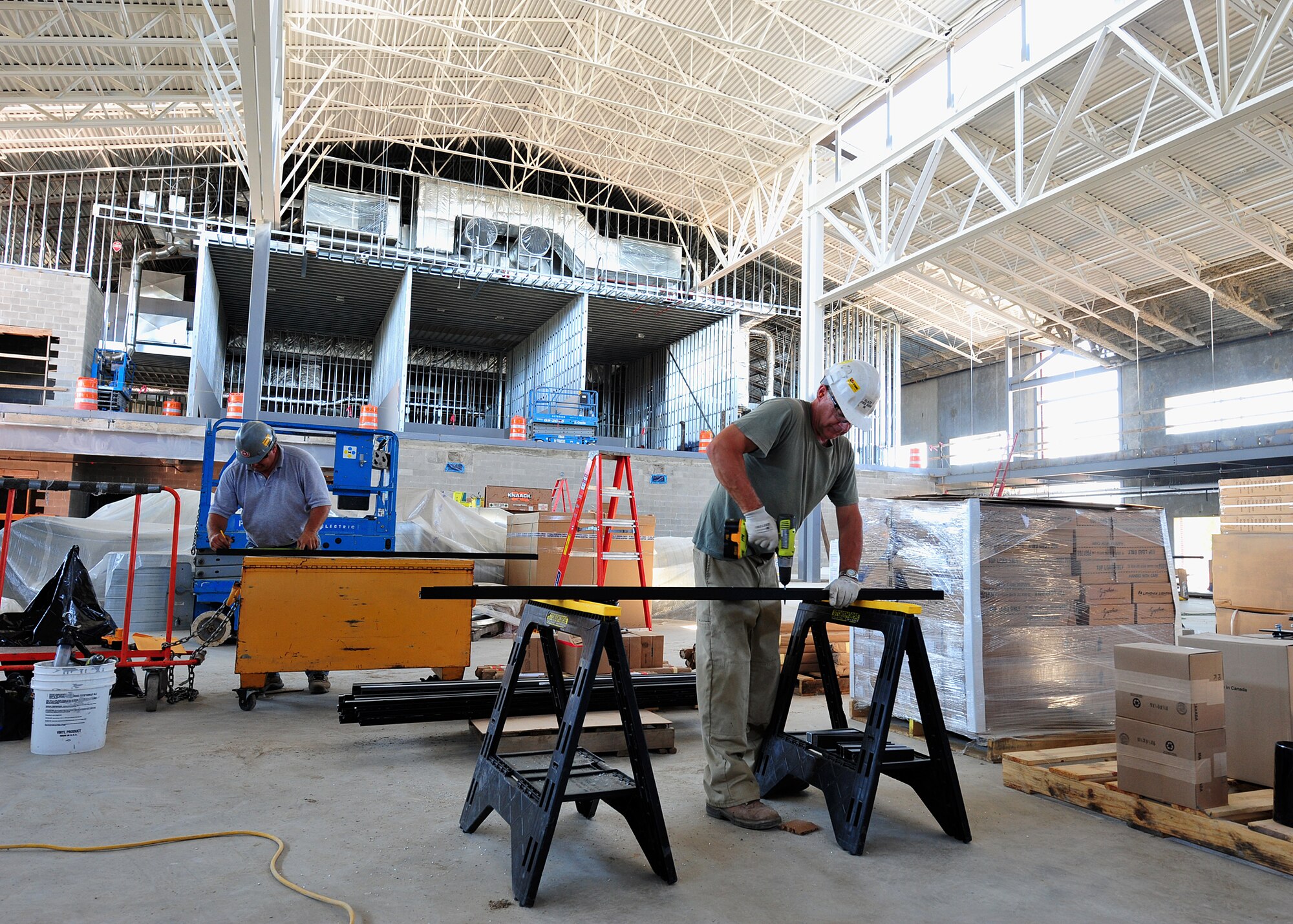 Lydig construction workers prepare building materials in the new Fairchild fitness center Sept. 8. The $19.7 million project was necessary because the current fitness center was originally constructed as an unheated, wood warehouse in 1943, it wastes energy and is very costly to maintain. (U.S. Air Force photo/Staff Sgt. Michael Means)

