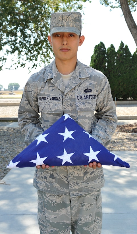 MOUNTAIN HOME AIR FORCE BASE, Idaho – Staff Sgt. Luis Porras Vargas, base honor guard non commissioned officer in charge, holds a folded United States of America flag Sept. 7. According to Air Force Pamphlet 34-1202 flags play an important role in every military ceremony, and there are formal rules of etiquette with regard to their use and display. (U.S. Air Force photo by Airman 1st Class Heather Hayward)