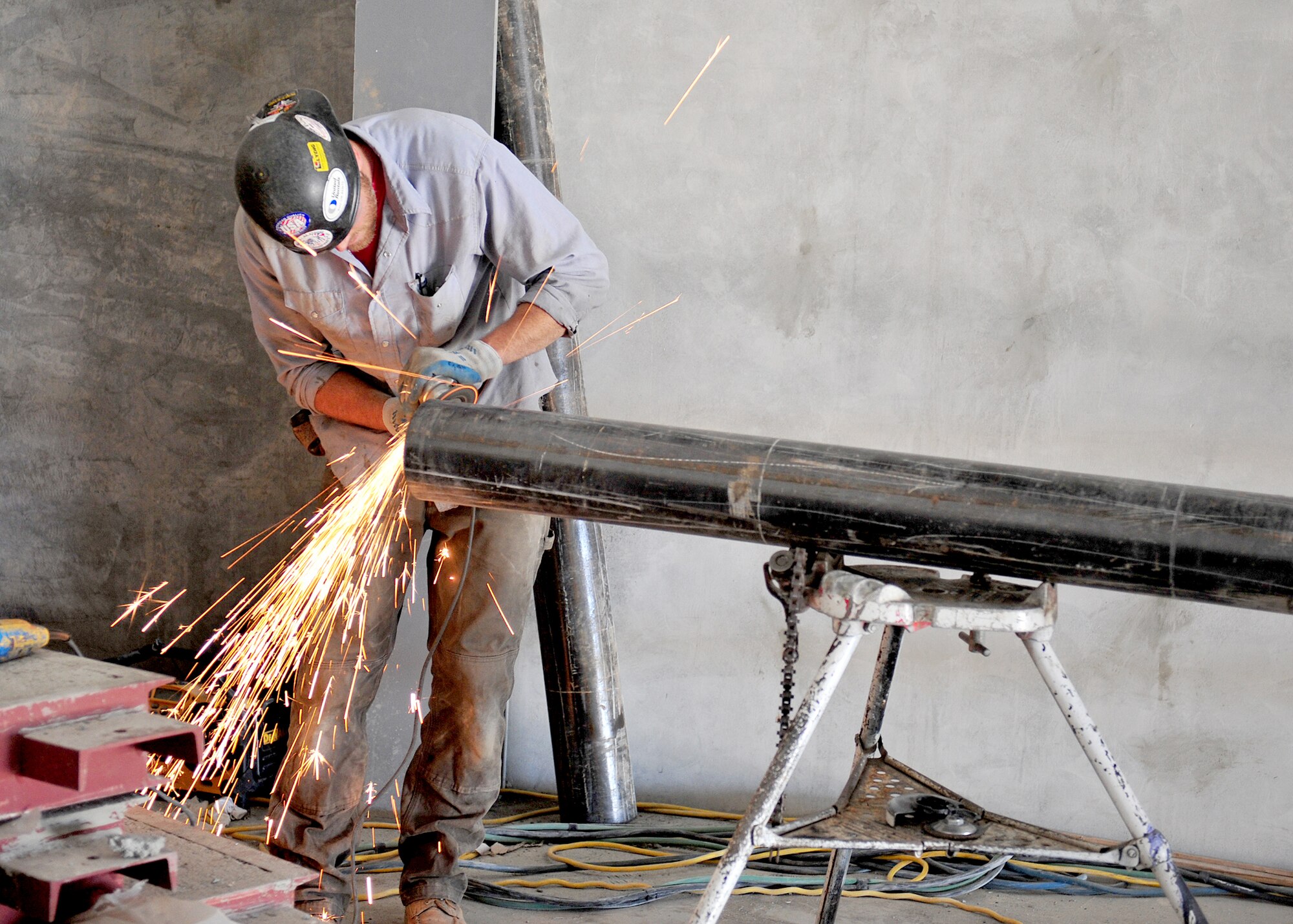 A Lydig construction worker prepares a pipe at the new Fairchild fitness center swimming pool Sept. 8. The pool is slated to be 14-feet deep and more user-friendly for patrons. (U.S. Air Force photos/Staff Sgt. Michael Means)