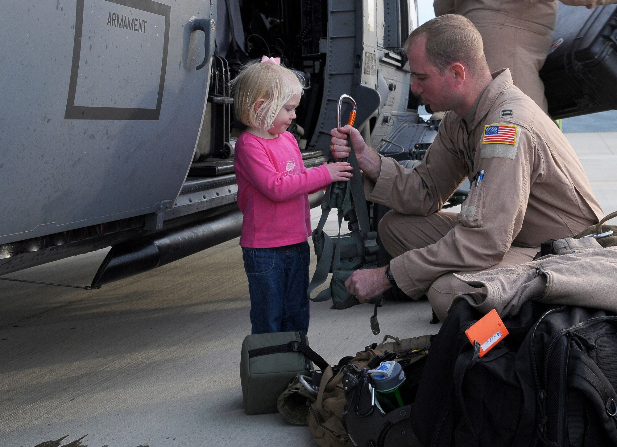 ROYAL AIR FORCE LAKENHEATH, England – Chole Adams (3) helps her dad Capt. Gary Adams, 56th Rescue Squadron HH-60G Pave Hawk co-pilot, gather his belongings, September 15, 2011.  Approximately 60 members from the 56th Rescue Squadron and 748th Aircraft Maintenance Squadron returned home after back-to-back deployments lasting more than nine months in support of Operations Enduring Freedom, Odyssey Dawn and Unified Protector.  The 56th RQS  is a combat-ready search and rescue squadron of HH-60G Pave Hawk helicopters capable of executing all-weather search and rescue missions day or night in hostile environments in support of the United States and its allies. (U.S. Air Force photo by Staff Sgt. Connor Estes)