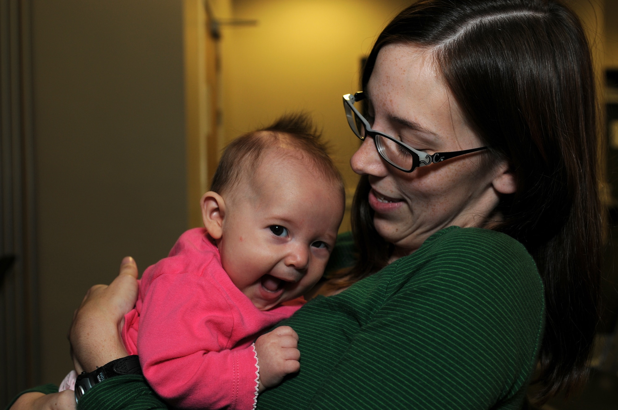 ROYAL AIR FORCE LAKENHEATH, England – Audra Wheeler hugs her 3-month-old daughter, Teagan, before reuniting with her husband Sept. 15, 2011. Approximately 60 Airmen from the 56th Rescue Squadron and 748th Aircraft Maintenance Squadron returned home after back-to-back deployments lasting more than nine months in support of Operations Enduring Freedom, Odyssey Dawn and Unified Protector. (U.S. Air Force photo by Airman Cory D. Payne)