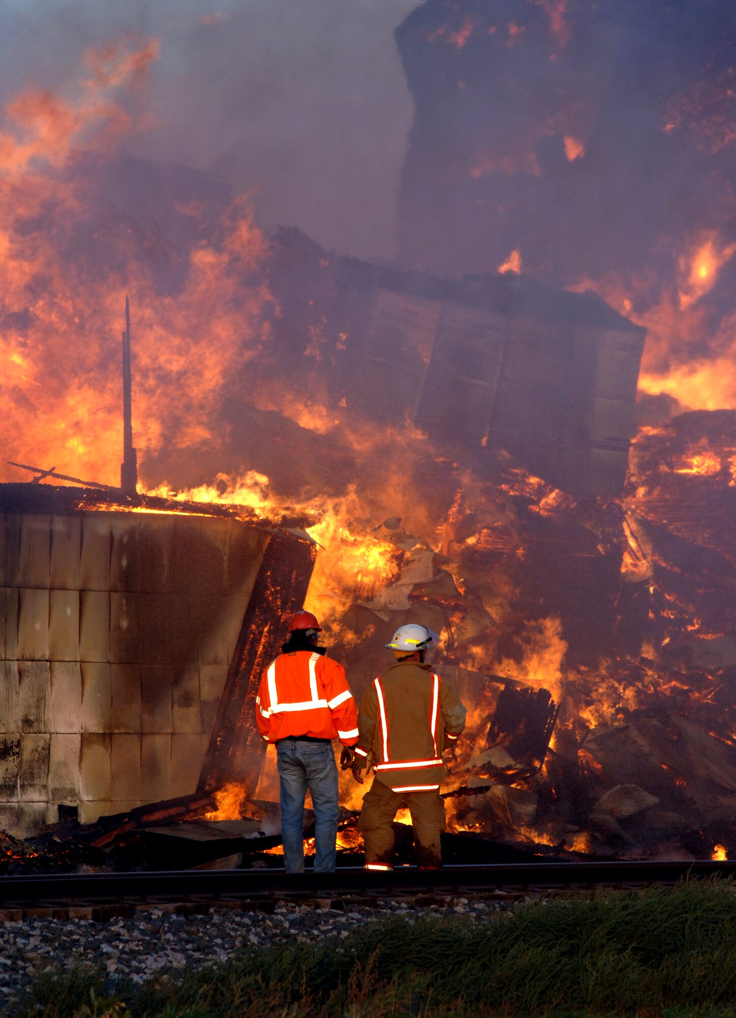 Firefighters are dwarfed by a massive fire in a grain elevator in Forest River, N.D., on Sept. 13. Personnel from Grand Forks Air Force Base, about 20 miles south of Forest River, helped deliver thousands of gallons of fuel to assist as part of a mutual agreement with the town. (U.S. Air Force photo/Tim Flack)