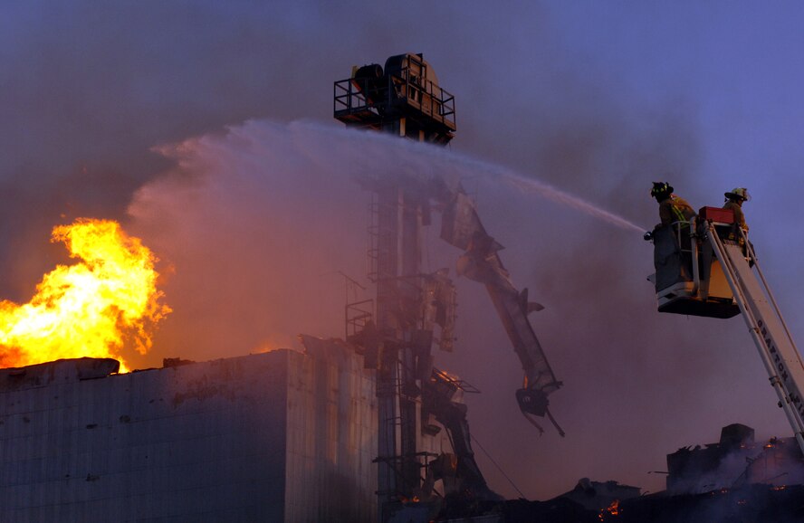 Local firefighters battle a blaze in a grain elevator in Forest River, N.D., about 20 miles north of Grand Forks Air Force Base, on Sept. 13. Base personnel delivered thousands of gallons of water to the scene as part of a mutual aid agreement to assist in case of an emergency. (U.S. Air Force photo/Tim Flack)
