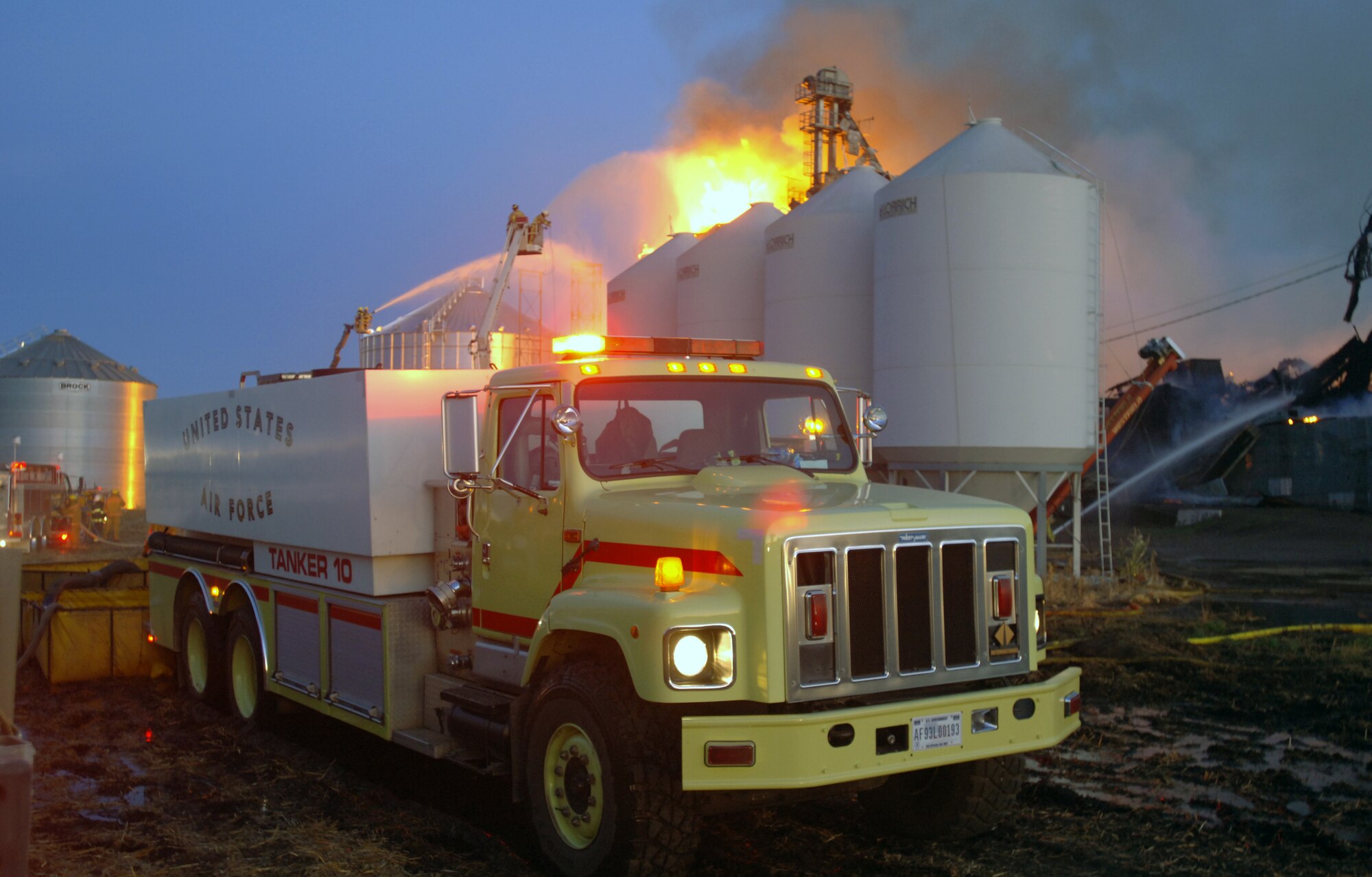 Firefighters from Grand Forks Air Force Base, N.D., helped transport thousands of gallons of water to Forest River, about 20 miles north of the base, to help local personnel fight a massive blaze in a grain elevator on Sept. 13. (U.S. Air Force photo/Tim Flack)