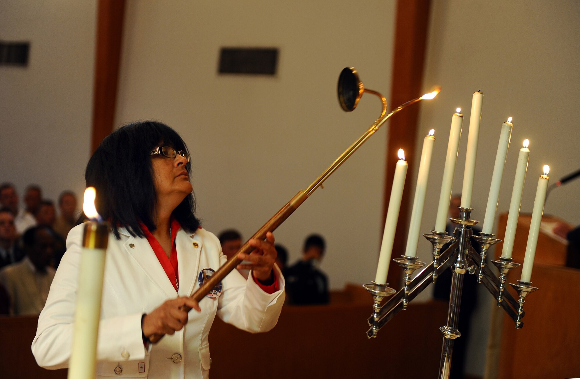 Yolanda Robles, lights a candle in remembrance of her son during a memorial service held at the SAC Chapel on Offutt Air Force Base, Neb., Sept. 9.  U.S. Marine Corps Cpl. Adrian Robles, from Scottsbluff, Neb., lost his life in Afghanistan in 2008. (U.S. Air Force photo by Josh Plueger/Released)