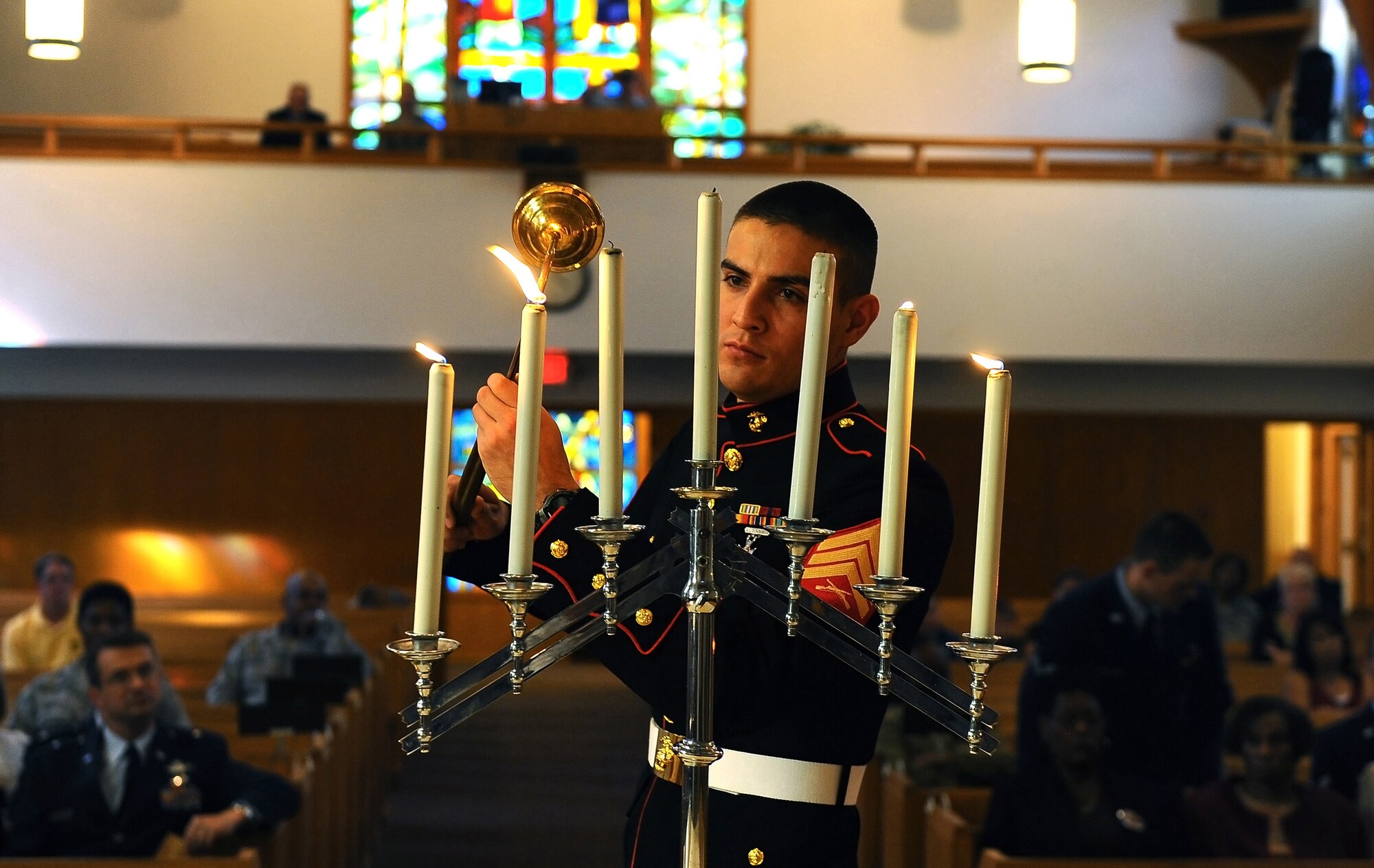 U.S. Marine Corps Sergeant Gerald Foote, lights a candle in remembrance of the events of 9/11 during a memorial service held at the SAC Chapel on Offutt Air Force Base, Neb., Sept. 9.  Members from each branch of the military lit a candle along with grieving parents who've lost sons or daughters in military campaigns. (U.S. Air Force photo by Josh Plueger/Released)
