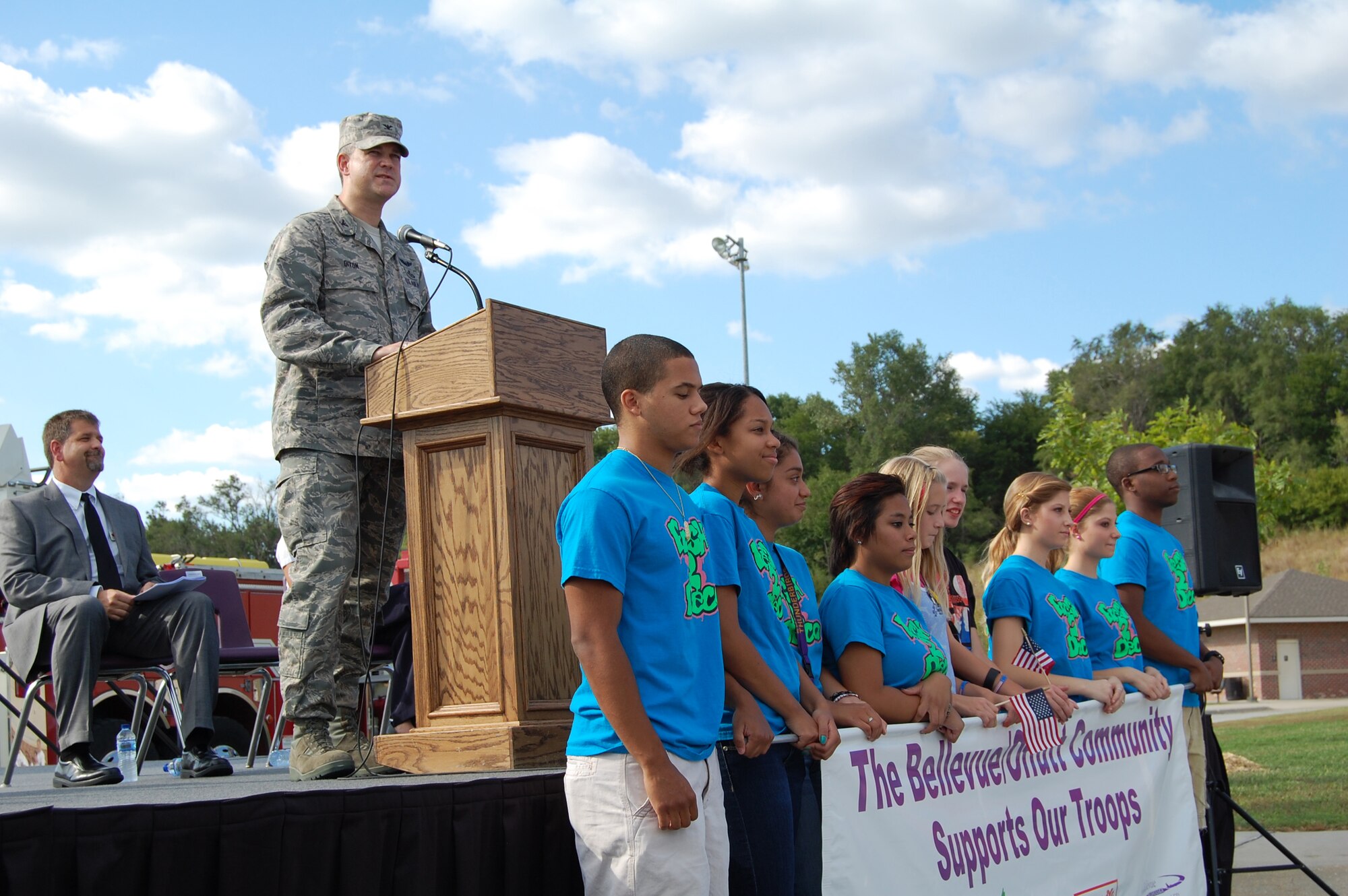 Col. Kevin Dixon, 55th Wing vice commander, speaks to a crowd at the Lied Activity Center in Bellevue, Neb., as part of the sixth annual America Supports You Freedom Walk ceremony Sept. 8. Dixon thanked the Bellevue community for the support they provide to Team Offutt on a daily basis. (U.S. Air Force photo by Senior Airman Peter R.O. Danielson/Released)