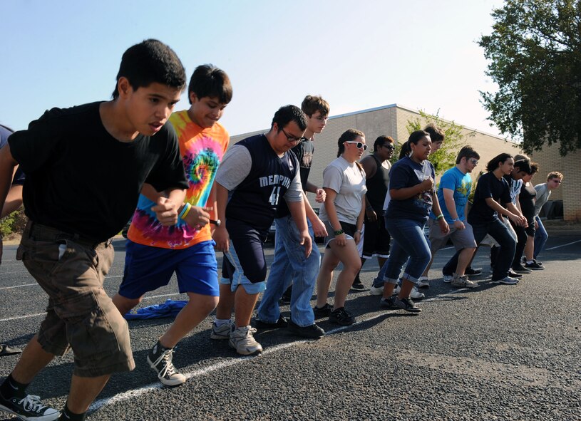 Students at The Academy of Technology, Engineering, Math and Science, Abilene, Texas run outside September 13, 2011, for a mock physical training test during Dyess Week. Dyess Week continues Dyess’ partnership with the Abilene community by supporting local schools’ fitness programs, educate the community on Dyess’ mission and raise awareness for the 64th anniversary of the Air Force’s birthday. (U.S. Air Force photo by Airman 1st Class Courtney Moses/Released) 