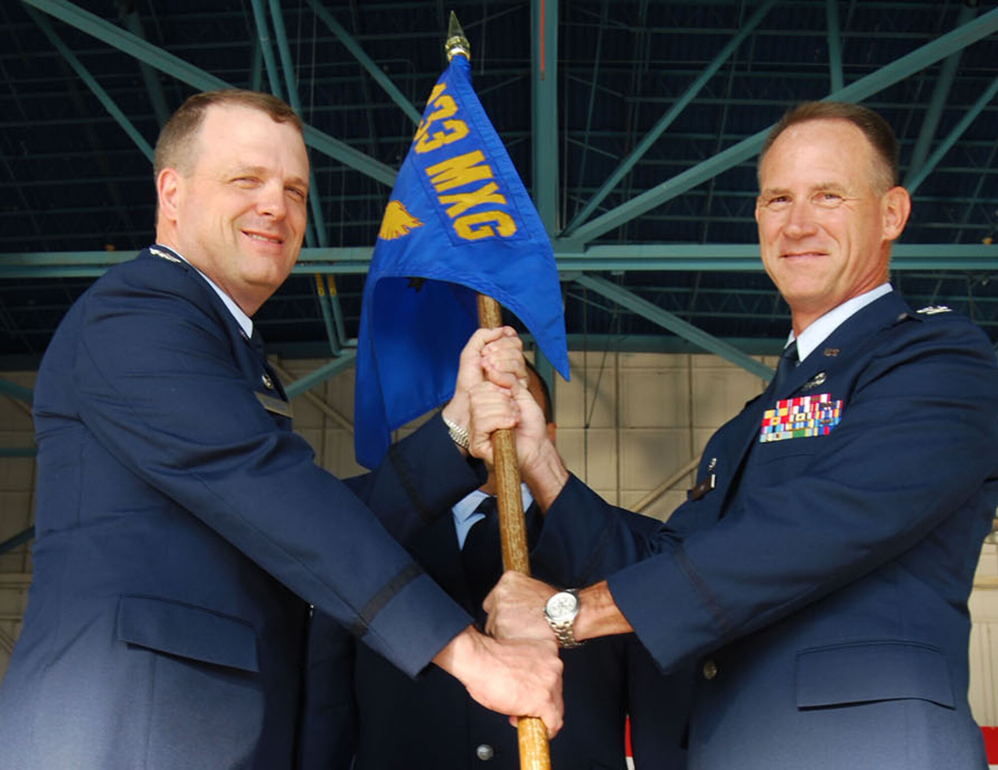 Col. Charles M. Combs, right, accepts the guidon and command of the 433rd Maintenance Group from 433rd Mission Support Group commander, Col. Craig S. Petersen, on Sept. 11, 2011, during an assumption of command ceremony at the 433rd Airlift Wing fuel cell at Lackland Air Force Base, Texas. (U.S. Air Force photo/Master Sgt. Collen McGee)