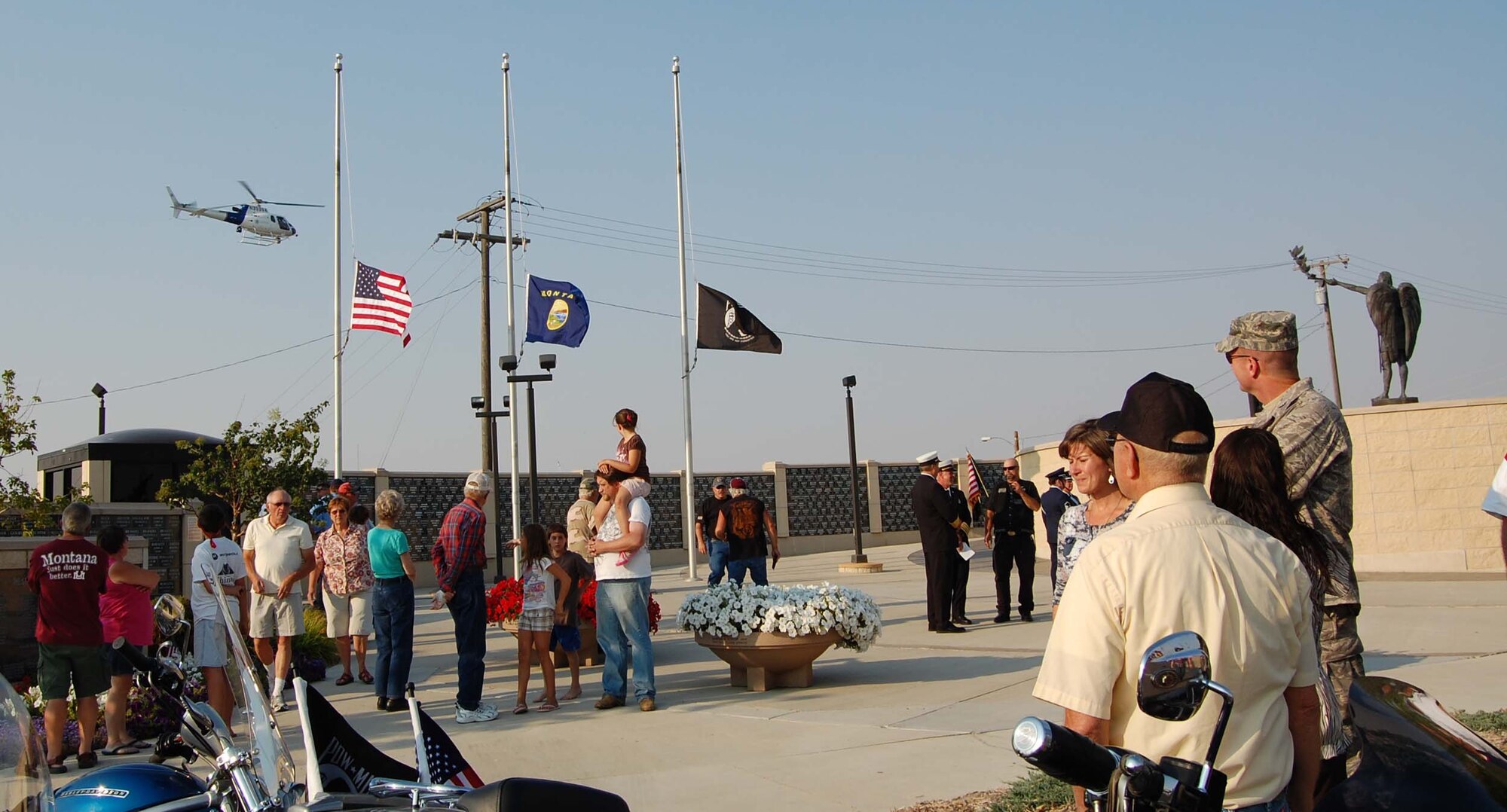 Spectators looke to the ski as a Department of Homeland Security helicopter does a final fly over. The aircraft also accompanied the riders from the Harley Davidson store on 10th Avenue South to their final destination, Veteran's Memorial Park, during the 9/11 Freedom Ride Sunday. (U.S. Air Force photo/Valerie Mullett)