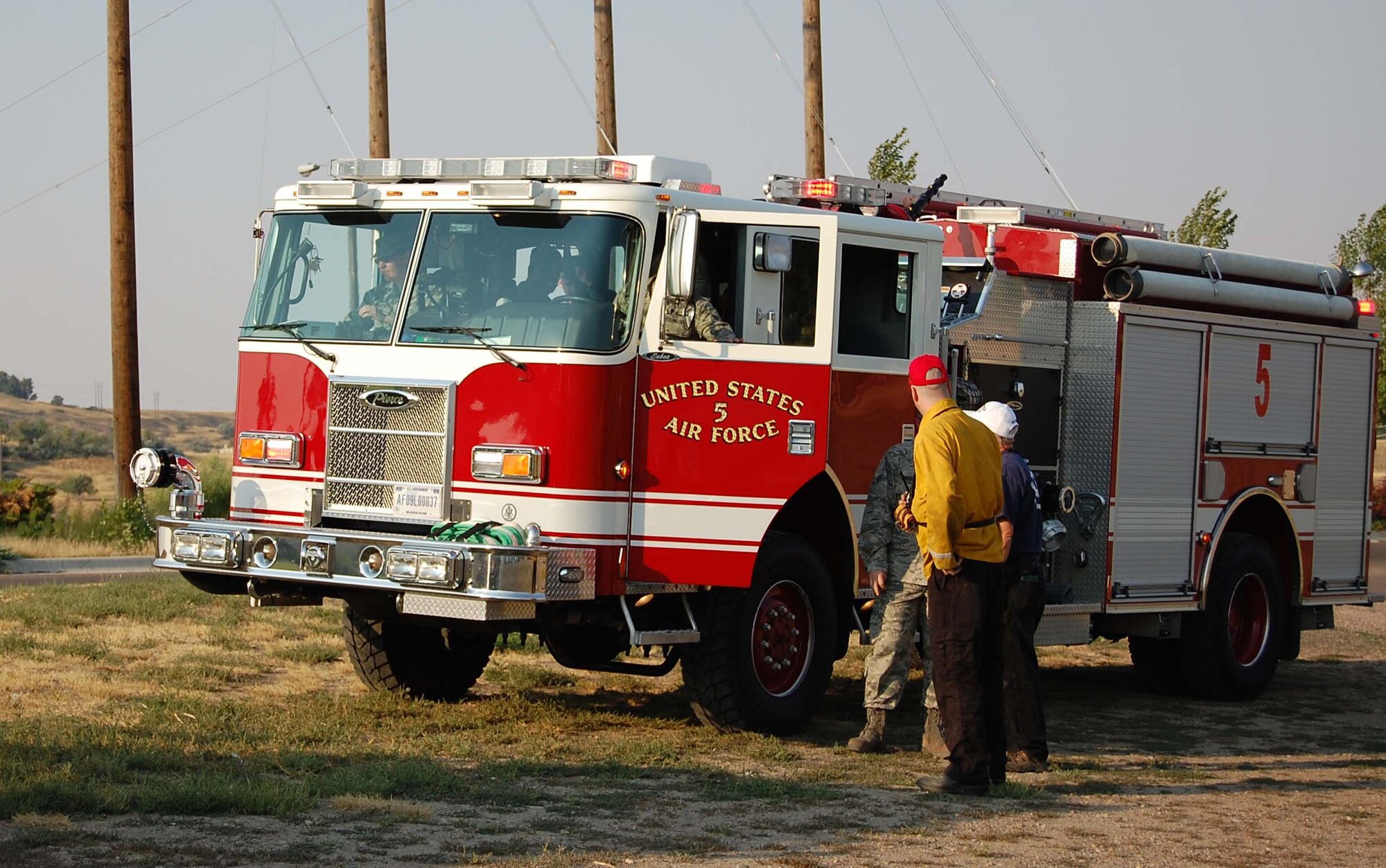 Members of Malmstrom's fire department chat with members of the Black Eagle fire department after arriving at Veteran's Memorial Stadium Saturday. The two groups also participated in the 9/11 Freedom Ride. (U.S. Air Force photo/Valerie Mullett)
