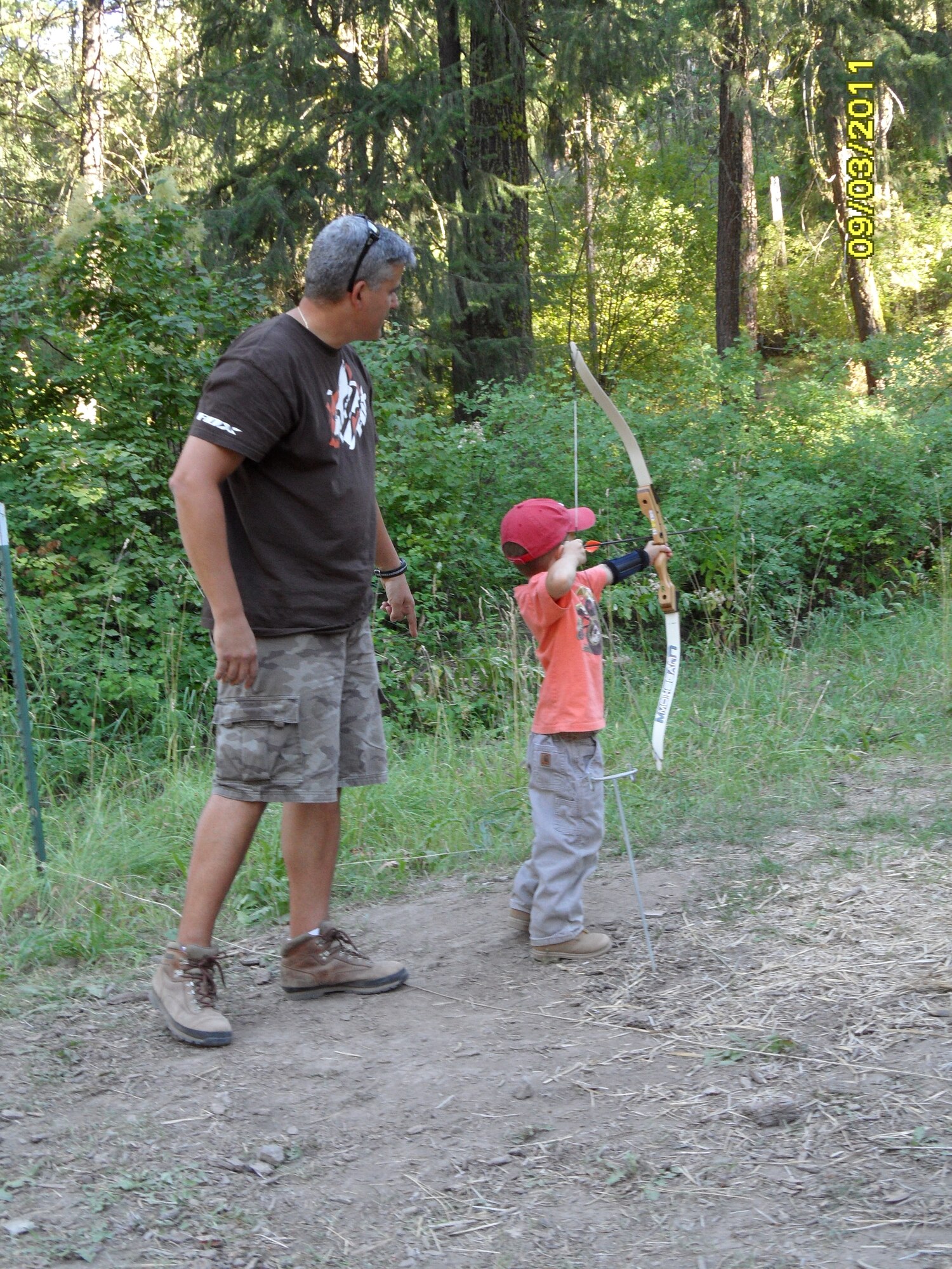 Lt. Col. Michael Felice, 92nd Maintenance Squadron commander, helps teach Gabe, his 4-year-old son, how to shoot archery in Ellensburg, Wash. Sept 12. (U.S. Air Force photo/Col. Thomas Roshetko) 
