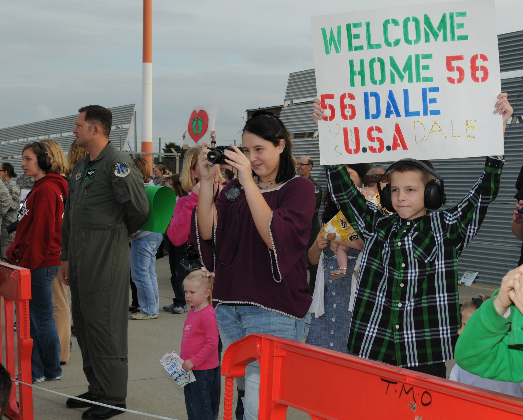 ROYAL AIR FORCE LAKENHEATH, England - Families eagerly await the return of members of the 56th Rescue Squadron September 15, 2011. Approximately 60 members from the 56th Rescue Squadron returned home after back-to-back deployments lasting more than nine months in support of Operations Enduring Freedom, Odyssey Dawn and Unified Protector.  The 56th RQS  is a combat-ready search and rescue squadron of HH-60G Pave Hawk helicopters capable of executing all-weather search and rescue missions day or night in hostile environments in support of the United States and its allies. (U.S. Air Force photo by Airman Cory D. Payne)