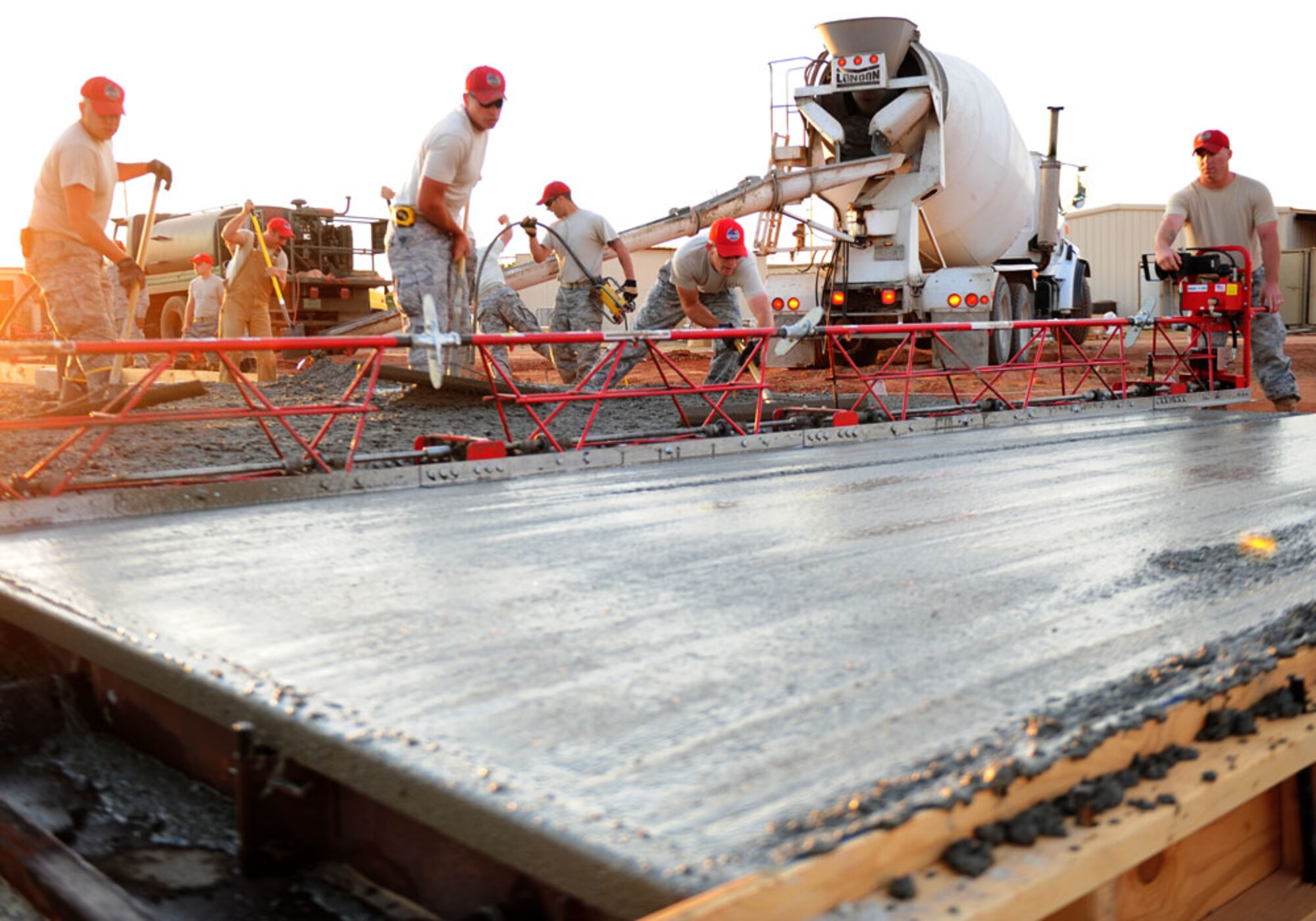 Airmen from the 819th Red Horse Squadron, Malstrom AFB, Mont., smoothes cconcrete Sept. 12, 2011, at Dyess AFB, Texas. Red Horse is constructing a 8,500-square-foot facility for CES craftsmen to perform maintenance duties and will also consolidate three other facilities being used by 7 CES. (U.S. Air Force photo by Senior Airman Chelsea Browning/ Released)