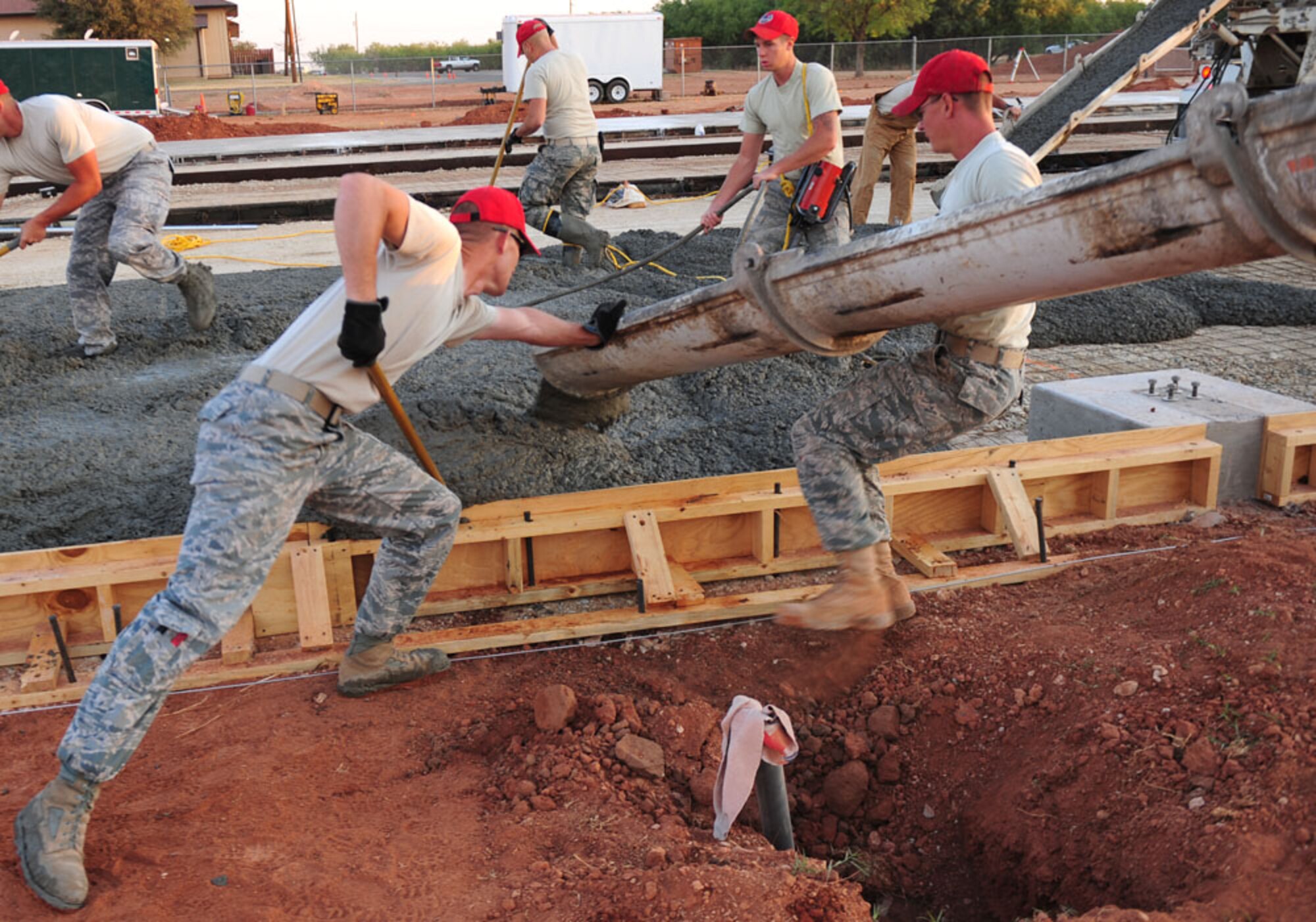 Airmen from the 819th Red Horse Squadron, Malstrom AFB, Mont., pour concrete Sept. 12, 2011, at Dyess AFB, Texas. Red Horse is constructing a 8,500-square-foot facility for CES craftsmen to perform maintenance duties and will also consolidate three other facilities being used by 7 CES. (U.S. Air Force photo by Senior Airman Chelsea Browning/ Released)
