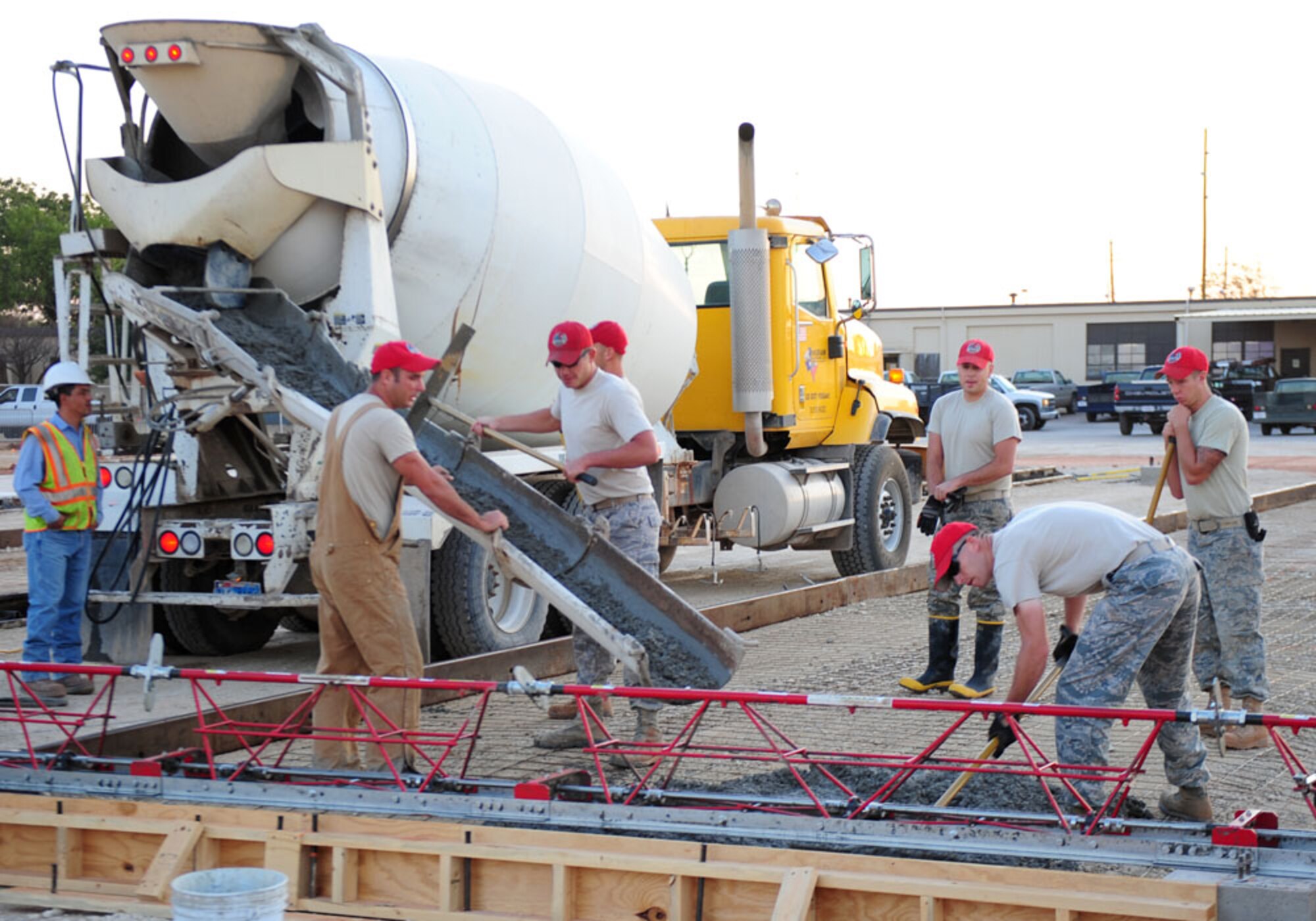 Airmen from the 819th Red Horse Squadron, Malstrom AFB, Mont., pour concrete Sept. 12, 2011, at Dyess AFB, Texas. Red Horse is constructing a 8,500-square-foot facility for CES craftsmen to perform maintenance duties and will also consolidate three other facilities being used by 7 CES. (U.S. Air Force photo by Senior Airman Chelsea Browning/ Released)