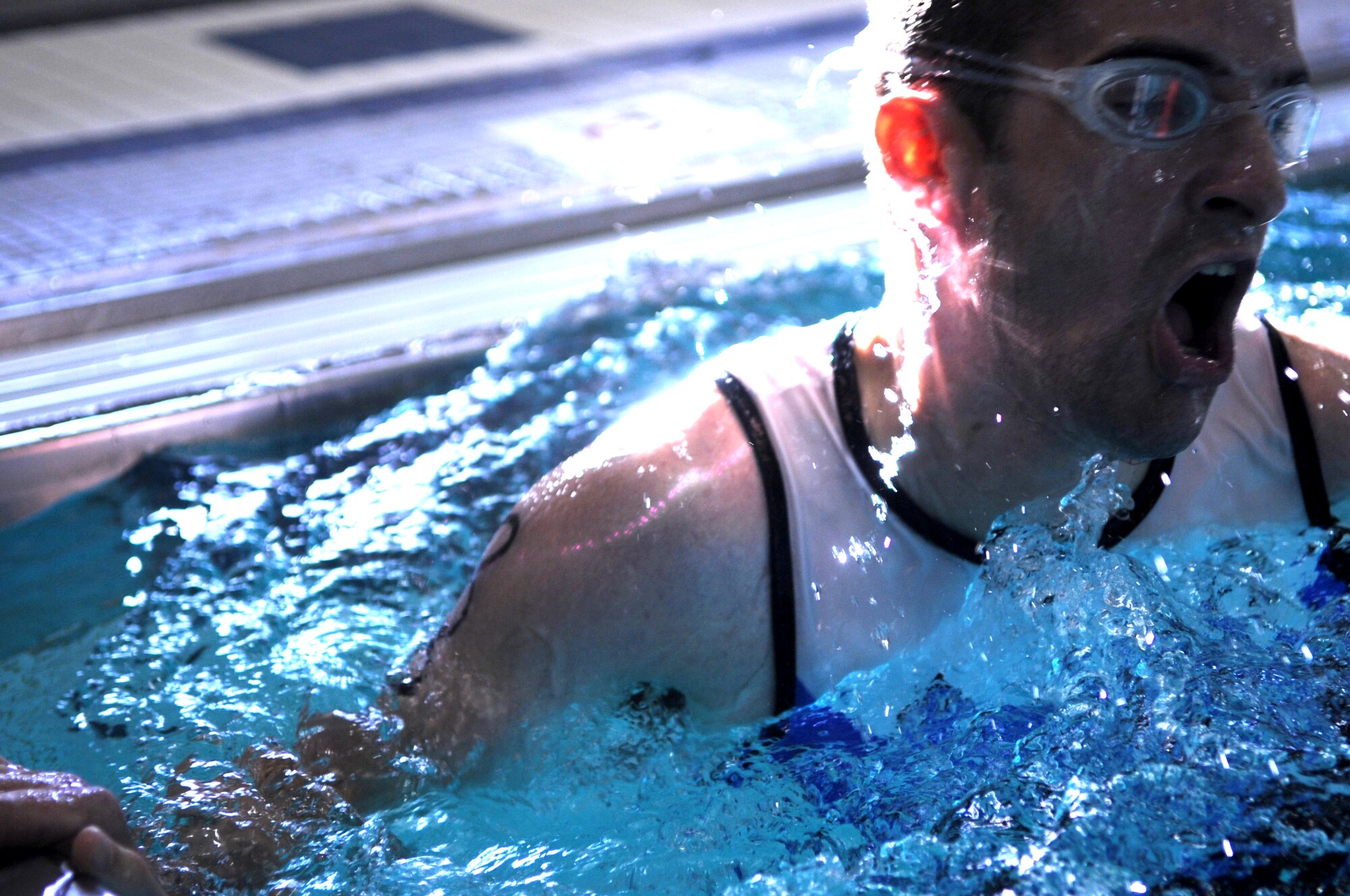 1st Lt. Daniel Bradfield, 10th Space Warning Squadron, takes a breath before beginning another lap in the Grand Forks Air Force Base gym pool Sept. 10. The swimming pool on GFAFB is indoors with areas designated for lap swim and recreational swimming along with a spacious pool-side lounge area with comfortable seating. (U.S. Air Force photo/Senior Airman Amanda N. Stencil)
