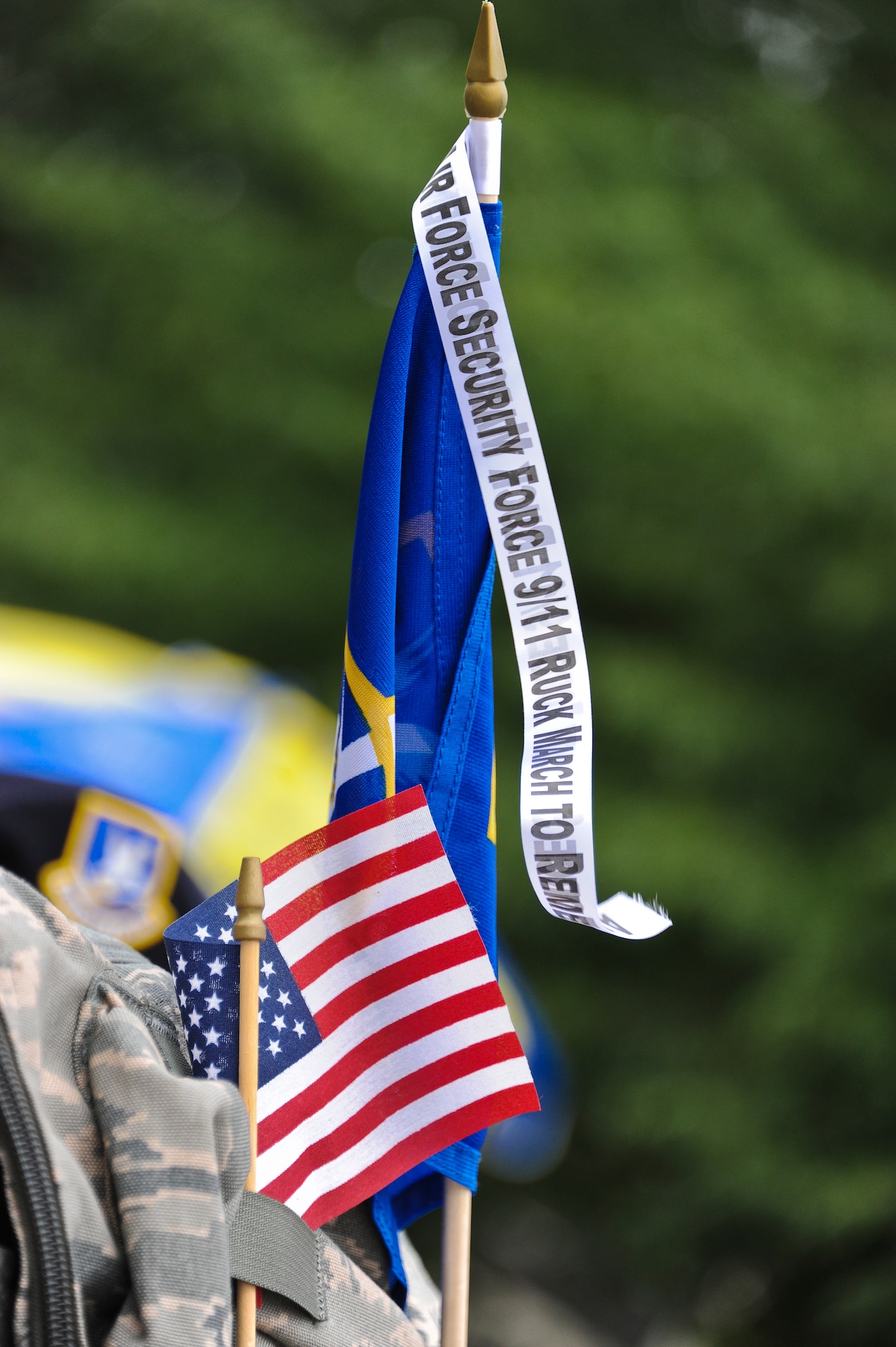 Joint Base McGuire-Dix-Lakehurst security forces members strapped an American flag and a Security Forces Defensive Fortis flag to their ruck sacks before setting out on the last leg of the Air Force 9/11 Ruck March to Remember Sept. 11. The security forces members marched from the Intrepid Sea, Air and Space Museum to Battery Park, where 2,796 flags covered the area to honor each person who died on 9/11. The ruck march started at Joint Base San Antonio, Texas July 17 and was completed with the help of 23 units carrying the guidon up to New York City.. (U.S. Air Force photo by Airman 1st Class Dennis Sloan/Released)