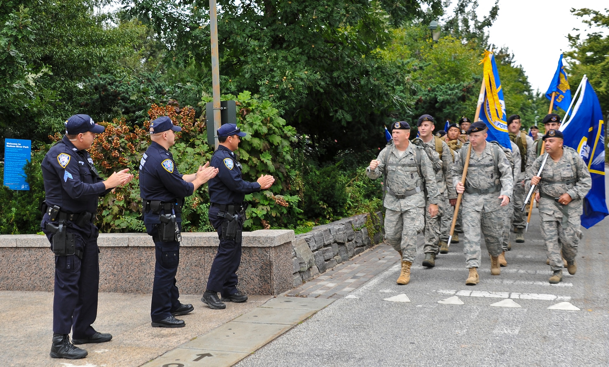 Joint Base McGuire-Dix-Lakehurst security forces members receive applause from New York City police officers as they march towards Battery Park Sept. 11. The security forces members started the last leg of a 2,100 mile ruck march at the Intrepid Sea, Air and Space Museum. The march began at Joint Base San Antonio, Texas July 17 and ended Sept. 11 at Battery Park where security forces members were met by New York citizens. (U.S. Air Force photo by Airman 1st Class Dennis Sloan/Released)
