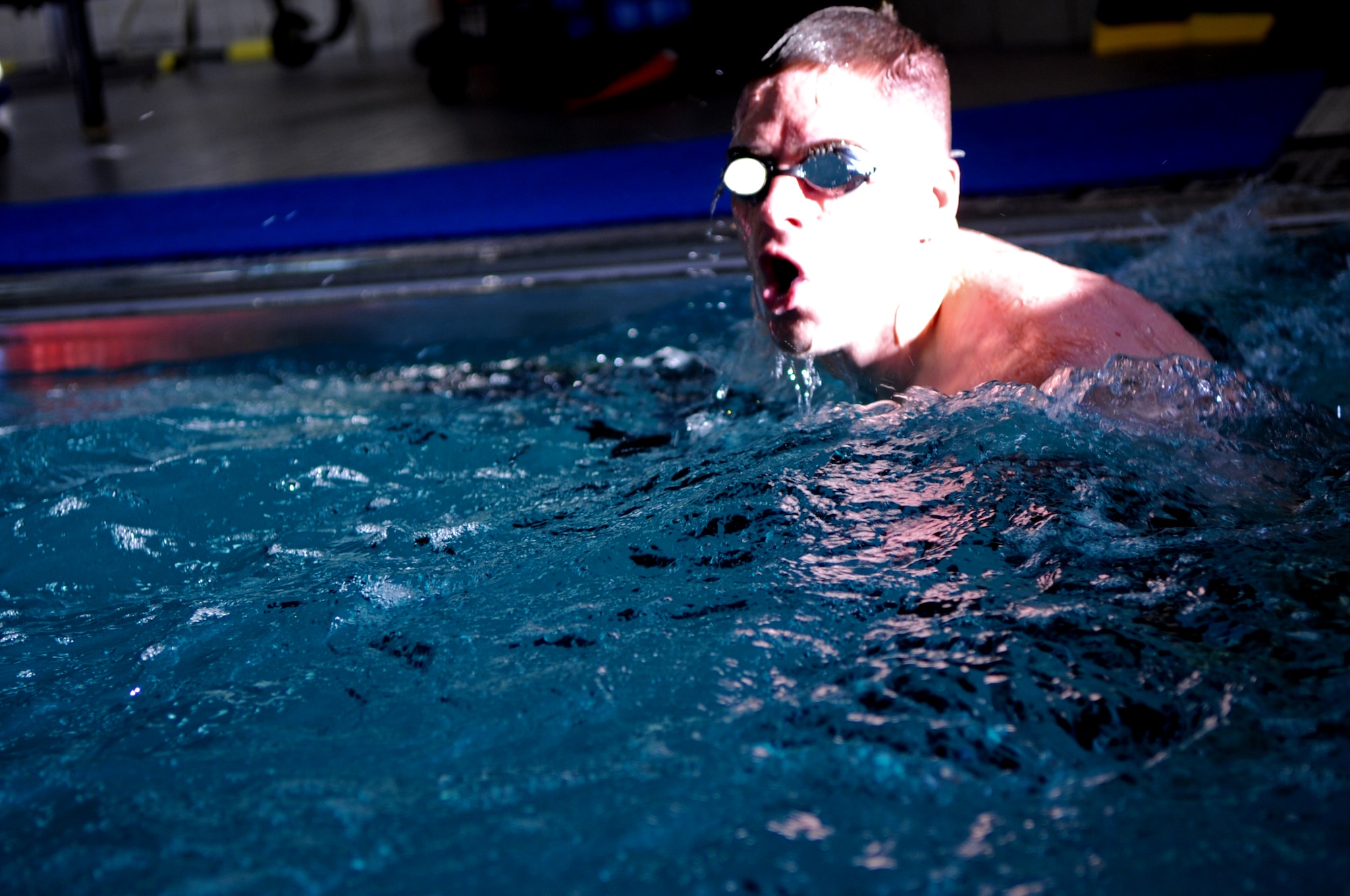 Capt. Andrew Stevens, 319th Medical Group, takes a quick breath before beginning another lap in the Grand Forks Air Force Base gym pool Sept. 10. The swimming pool on GFAFB is indoors with areas designated for lap swim and recreational swimming along with a spacious pool-side lounge area with comfortable seating. (U.S. Air Force photo/Senior Airman Amanda N. Stencil)