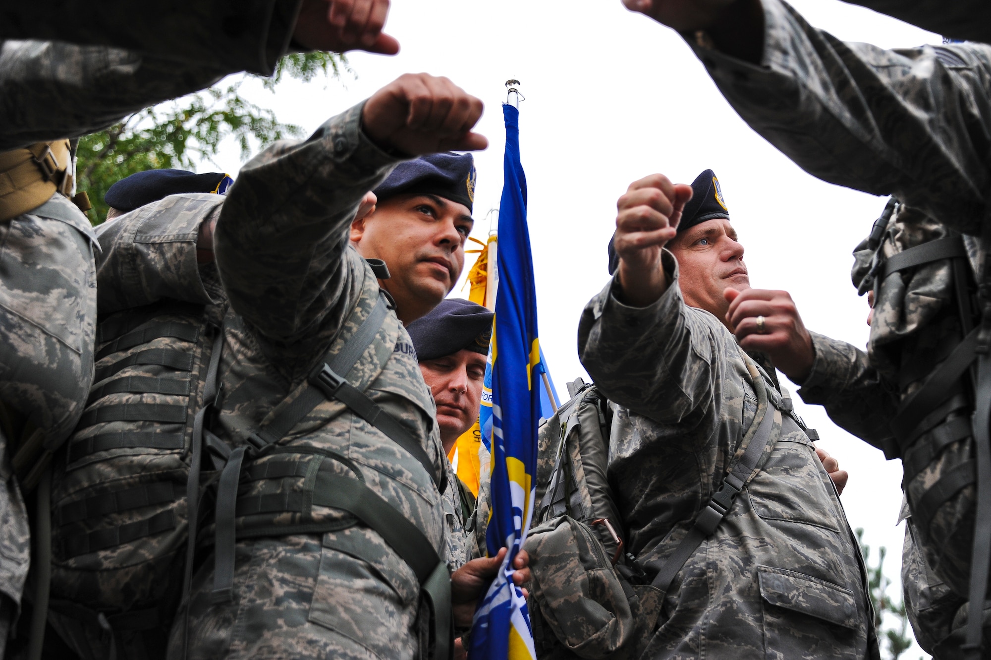 Joint Base McGuire-Dix-Lakehurst security forces members put their hands together before starting the last leg of the Air Force 9/11 Ruck March to Remember Sept. 11. The ruck march began at Joint Base San Antonio, Texas July 17 and ended at Battery Park in New York City, N.Y. Sept. 11. The park was filled with 2,796 flags in honor of each person who died on 9/11. (U.S. Air Force photo by Airman 1st Class Dennis Sloan/Released)