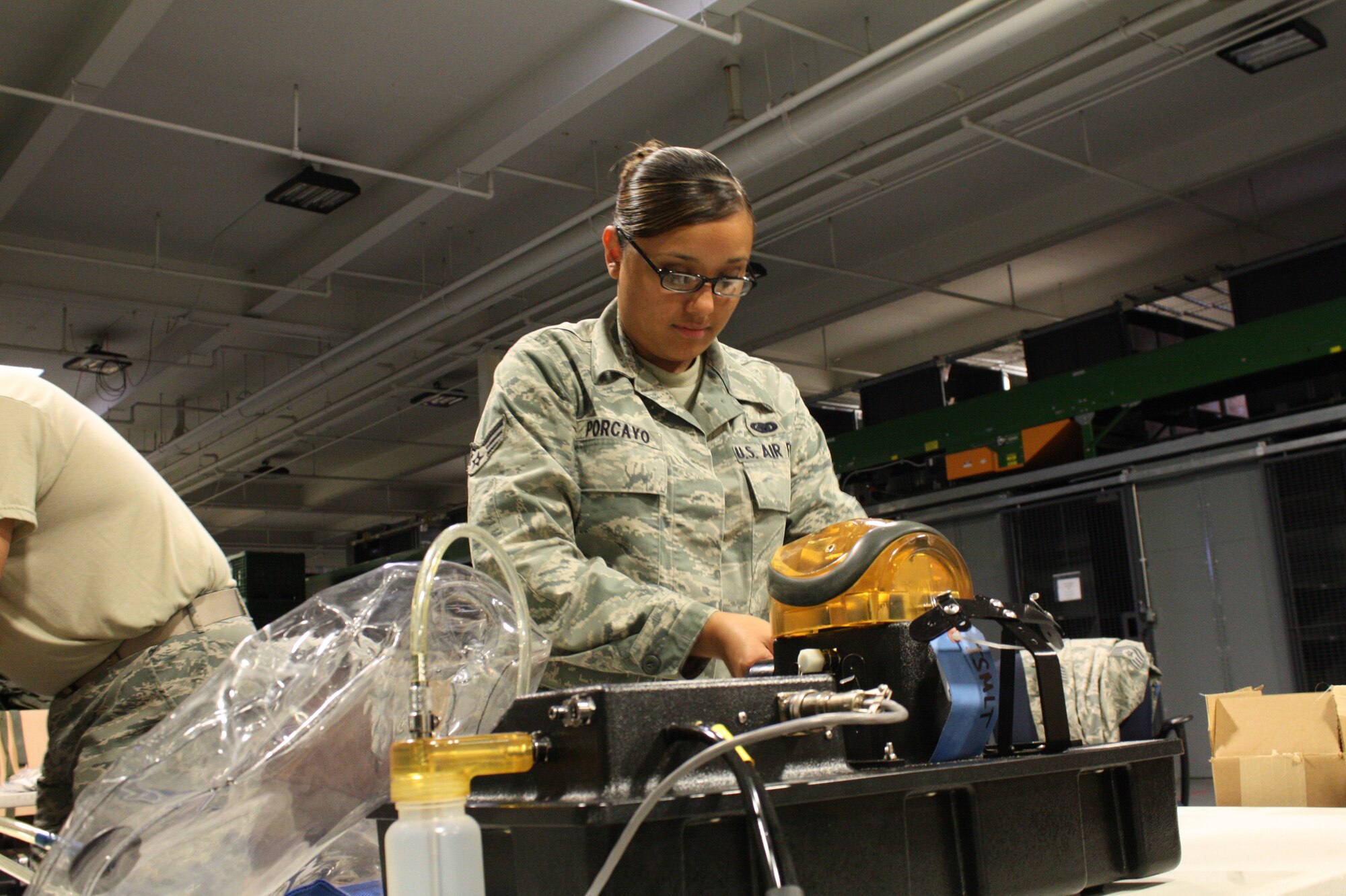 TRAVIS AIR FORCE BASE, Calif. -- Senior Airman Fabiola Porcayo, 349th Logistics Readiness Squadron, checks the status of a gas mask test during a routine inspection here on August 5, 2011. (U.S. Air Force photo by Senior Airman Amelia Leonard)