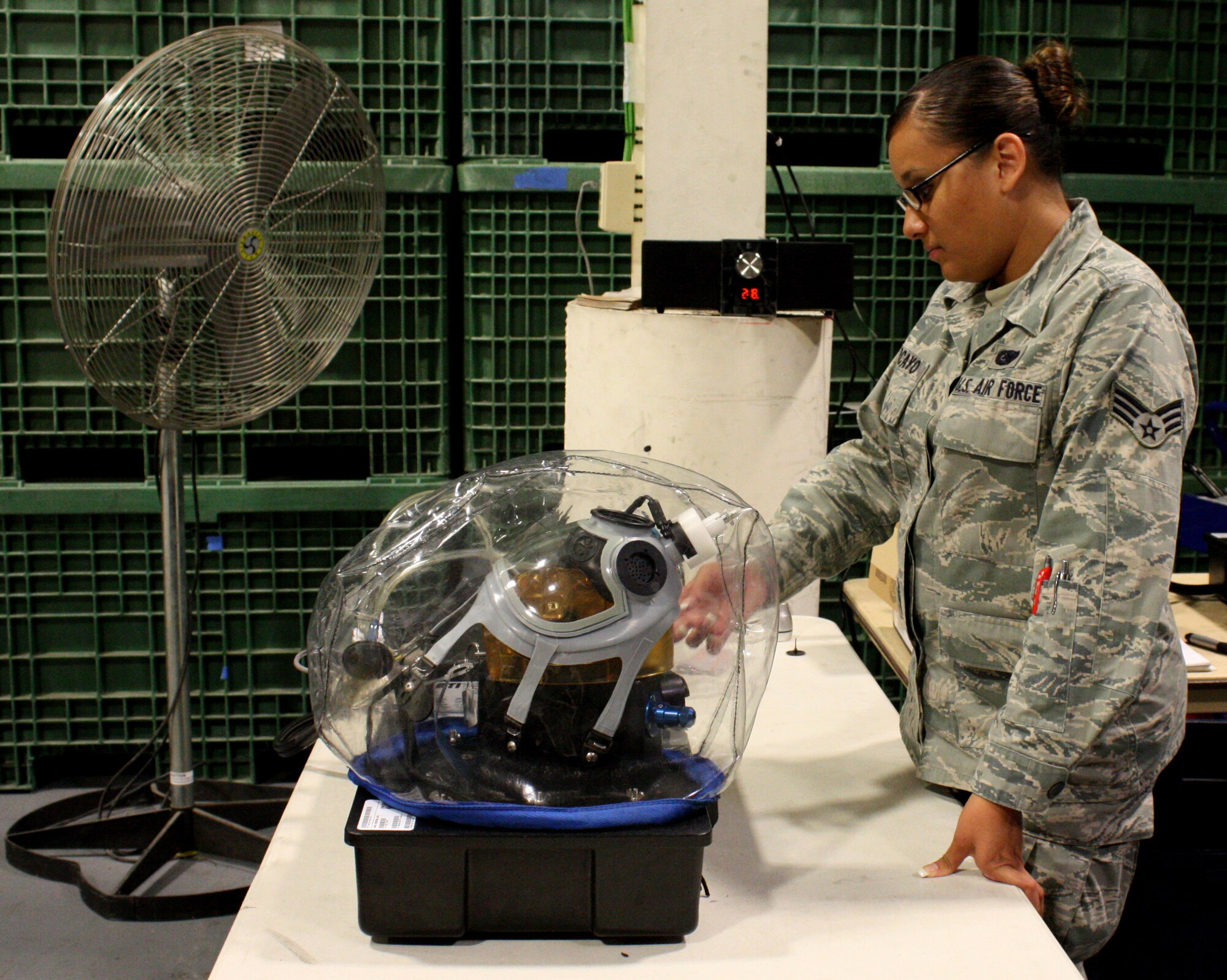 TRAVIS AIR FORCE BASE, Calif. -- Senior Airman Fabiola Porcayo, 349th Logistics Readiness Squadron, checks the status of a gas mask test during a routine inspection here on August 5, 2011. (U.S. Air Force photo by Senior Airman Amelia Leonard)