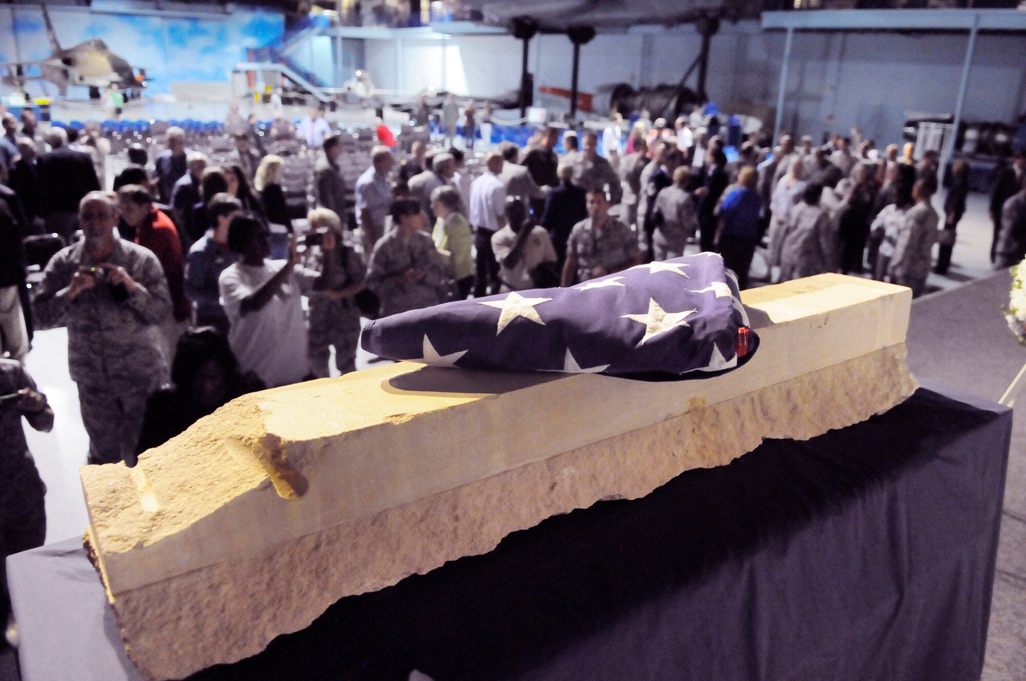 An American flag rests on a fragment of the west wall of the Pentagon from the attacks of Sept. 11. Following the ceremony, many Team Robins members paused to take photographs. U. S. Air Force photo by Sue Sapp