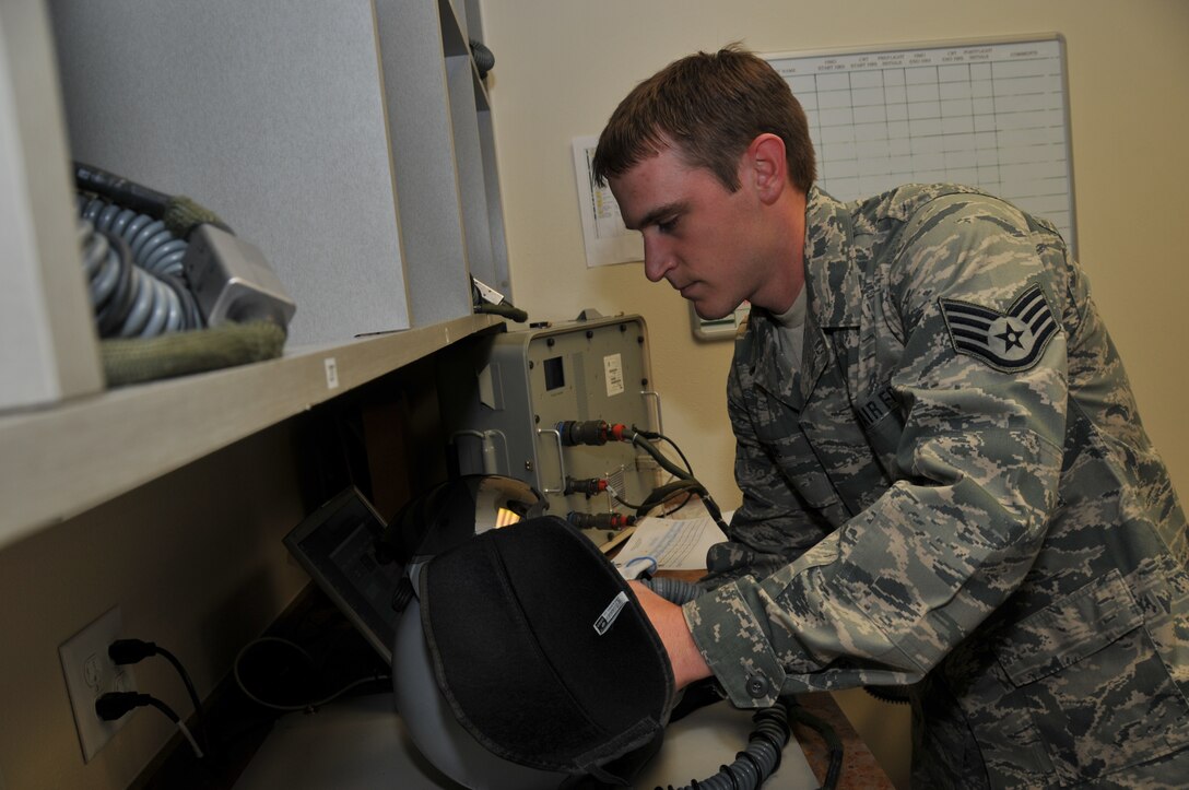 120th Fighter Wing Senior Airman Neil Kolve inspects a helmet during a post-flight check in the Aircrew Flight Equipment section on June 24, 2011.
(U.S. Air Force photo by Senior Master Sgt. Eric Peterson.)