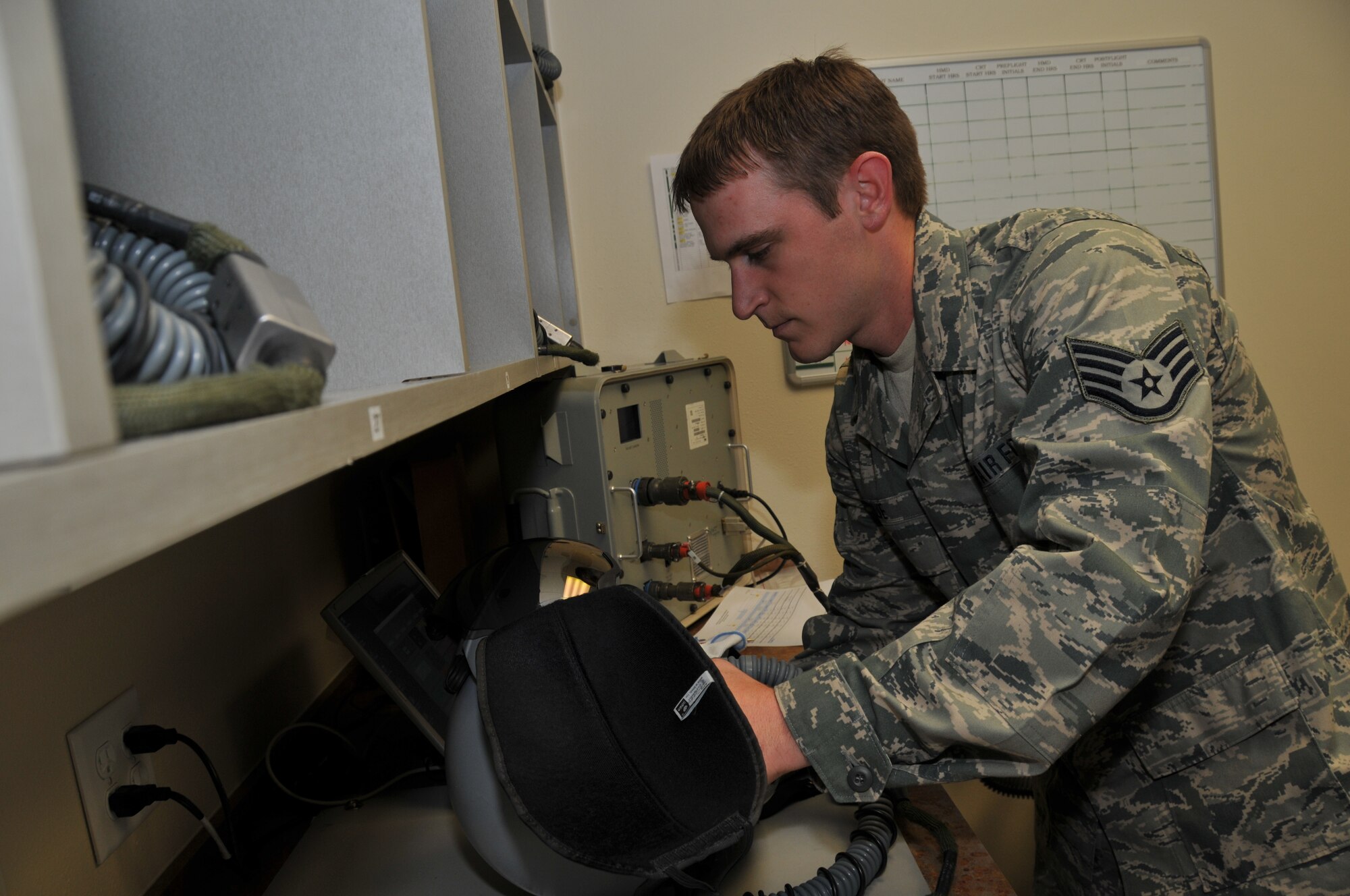 120th Fighter Wing Senior Airman Neil Kolve inspects a helmet during a post-flight check in the Aircrew Flight Equipment section on June 24, 2011.
(U.S. Air Force photo by Senior Master Sgt. Eric Peterson.)