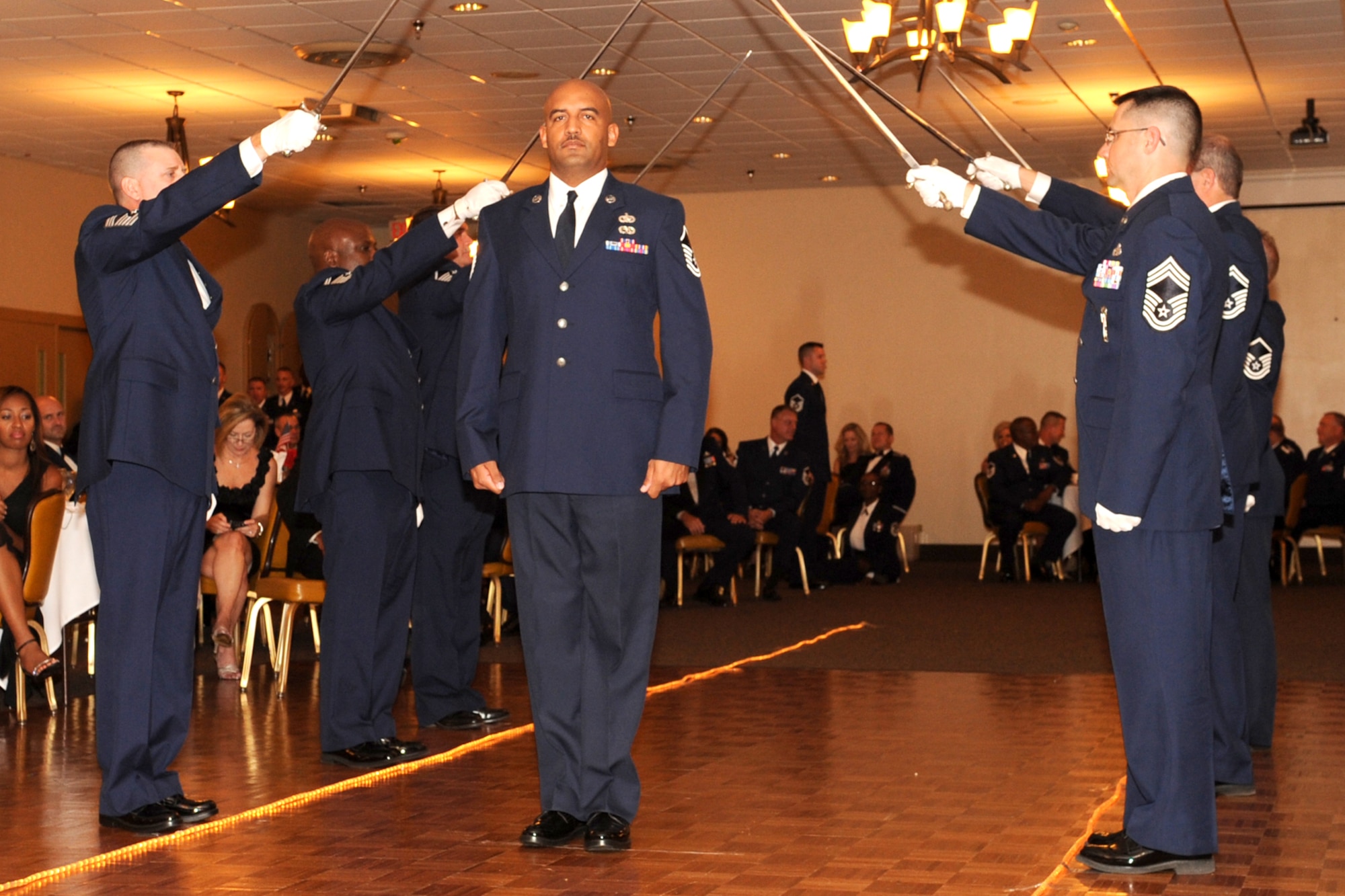 U.S. Air Force Master Sgt. Shaun Piernas passes underneath a sword cordon during the Senior Noncommisioned Officer Induction Ceremony at Barksdale Air Force Base, La., Sept. 10, 2011. The ceremony is held annually to recognize newly promoted Master Sgts. within the 307th BW, 917th Fighter Group and the 307th Rapid Engineer Deployable Heavy Operations Repair Squadron Engineers. (U.S. Air Force photo by Master Sgt. Greg Steele/Released)