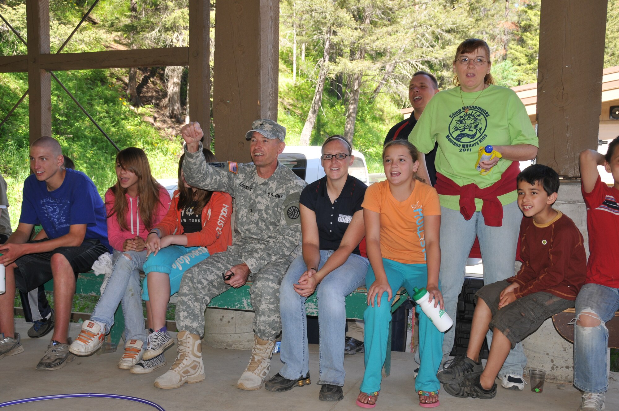 Brig. Gen. Joel Cusker leads the campers in a cheer at Camp Runnamucka, located in the Little Belt Mountains near Monarch, Mont. The week-long summer camp is organized to serve the children of Montana Army and Air National Guard and active duty
personnel. (U.S. Air Force photo by Senior Master Sgt. Eric Peterson.)