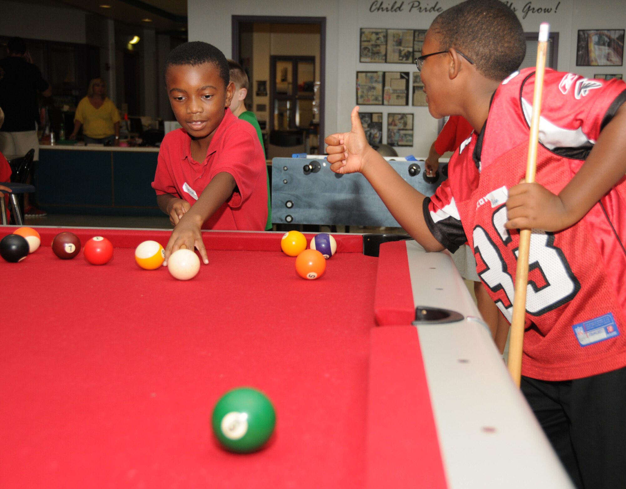 Left, Damian Dixon, 8, and Dylan Smith, 10, play pool during a free fun night Sept. 9, at the youth center sponsored by the Keesler Spouses Club. Dixon’s mom is Master
Sgt. Carmaneta Dixon, 335th Training Squadron.  Dylan’s parents are Tiffany and Master Sgt. Gregory Jackson, 85th Engineering Installation Squadron. The 155 children who attended were treated to free refreshments and enjoyed indoor and outdoor activities.  (U.S. Air Force photo by Kemberly Groue)