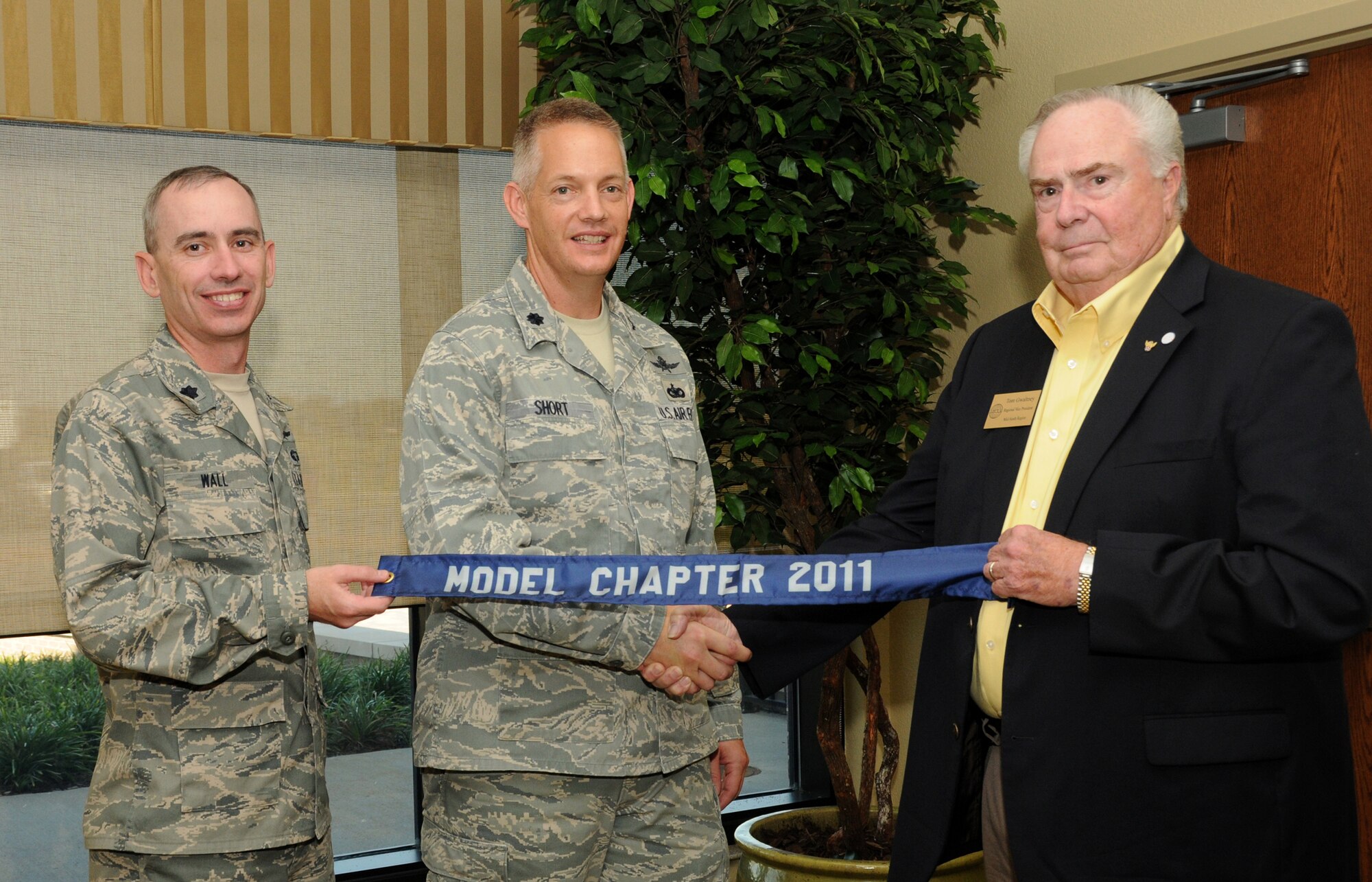 From left, Lt. Cols. Trevor Wall, vice president, and Douglas Short, president of the Armed Forces Communications and Electronics Association’s Gulf Coast Chapter, accept the AFCEA Model Chapter Award fromTom Gwaltney, the organization’s regional vice president, Sept. 7 at the Bay Breeze Event Center. Wall commands the 338th Training Squadron and Short commands the 333rd TRS. The award was announced in May at the Joint Warfighting Conference in Virginia Beach, Va. The award recognizes the top overall chapter structure and program of activities for the year.  (U.S. Air Force photo by Kemberly Groue)