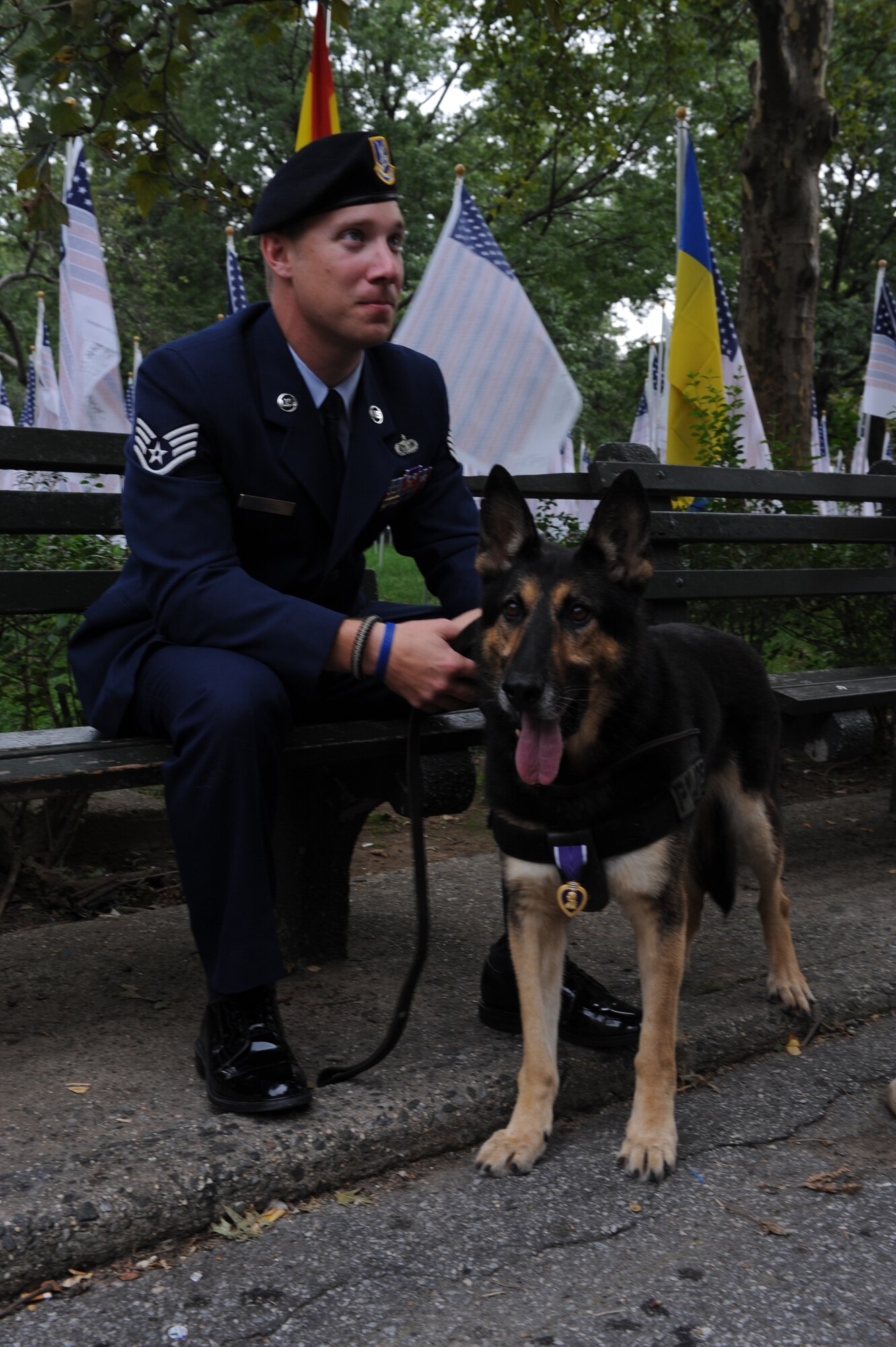 Staff Sgt. Benjamin Seekell and his military working dog Charlie pause for a moment of rest and reflection in New York Sept. 11, 2011.  Seekell and Charlie traveled to Battery Park to witness and participate in the final moments of the Security Forces 9/11 Ruck March to Remember.  Both wear the Purple Heart accolades they received after being hit by an improvised explosive device on Mother’s Day outside Bagram Airfield, Afghanistan.  Seekell lost his left leg and Charlie received shrapnel wounds to his hind quarters.  Seekell is a military working dog handler from the 4th Security Forces Squadron and is a native of Charlestown, R.I. (U.S. Air Force photo by 2nd Lieutenant Keavy Rake)