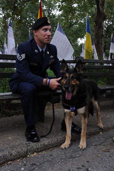 Staff Sgt. Benjamin Seekell and his military working dog Charlie pause for a moment of rest and reflection in New York Sept. 11, 2011.  Seekell and Charlie traveled to Battery Park to witness and participate in the final moments of the Security Forces 9/11 Ruck March to Remember.  Both wear the Purple Heart accolades they received after being hit by an improvised explosive device on Mother’s Day outside Bagram Airfield, Afghanistan.  Seekell lost his left leg and Charlie received shrapnel wounds to his hind quarters.  Seekell is a military working dog handler from the 4th Security Forces Squadron and is a native of Charlestown, R.I. (U.S. Air Force photo by 2nd Lieutenant Keavy Rake)