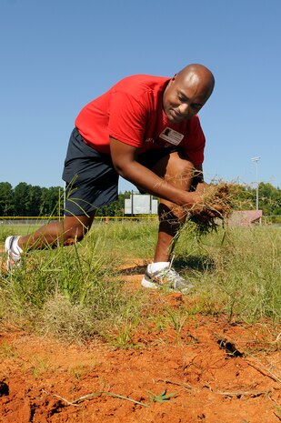 Chief Master-at-Arms Vincent Stephens from Naval Support Activity Charleston helps restore a baseball field at Baptist Hill Middle/High School Sept. 9. More than 20 chiefs and chief selects participated in the Trident United Way Day of Caring event. (U.S. Navy photo/Mass Communication Specialist 1st Class Jennifer Hudson