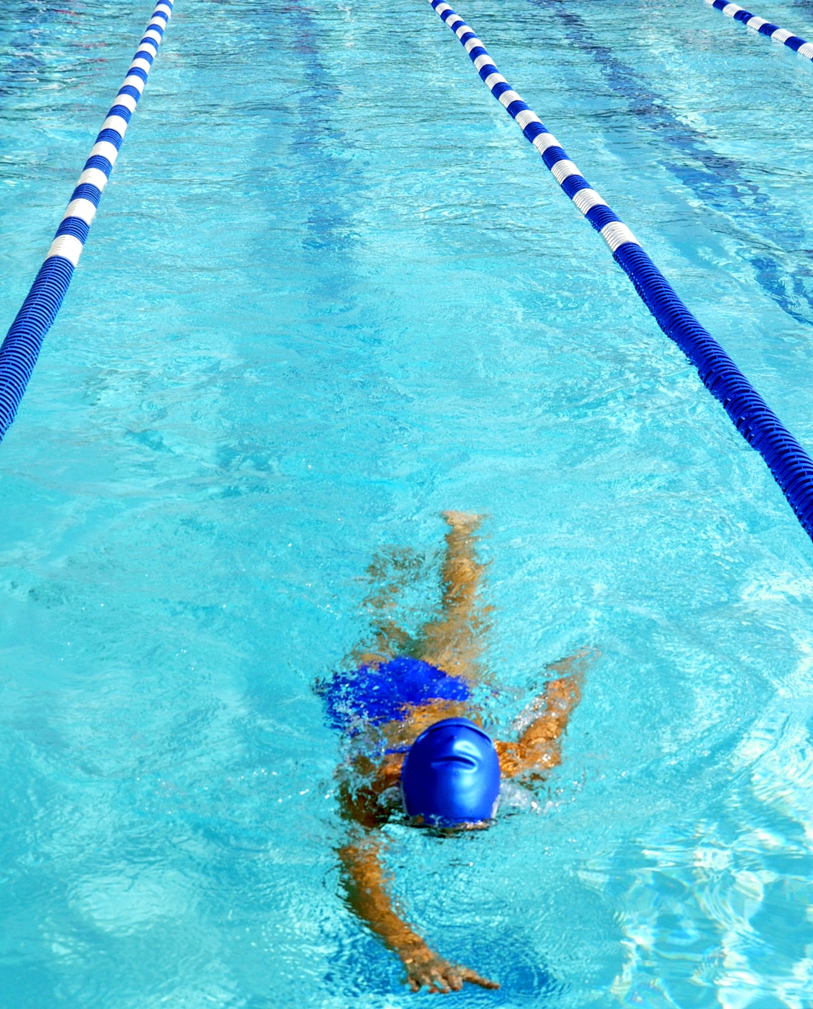 Katie Myszka, spouse of 1st Lt. Adam Myszka, finishes her 6th length of the pool with 14 more to go during the swimming portion of the Triathlon at the Travis Aquatic Center, Saturday. (U.S. Air Force photo/ Airman Madelyn Ottem)