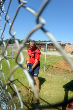 Chief (select) Machinist’s Mate Chris Huggins from Naval Consolidated Brig Charleston uses a weed-whacker during the Trident United Way Day of Caring event at Baptist Hill Middle/High School Sept. 9. More than 20 chiefs and chief selects participated in helping restore the public school’s baseball field during the community service event. (U.S. Navy photo/Mass Communication Specialist 1st Class Jennifer Hudson)
