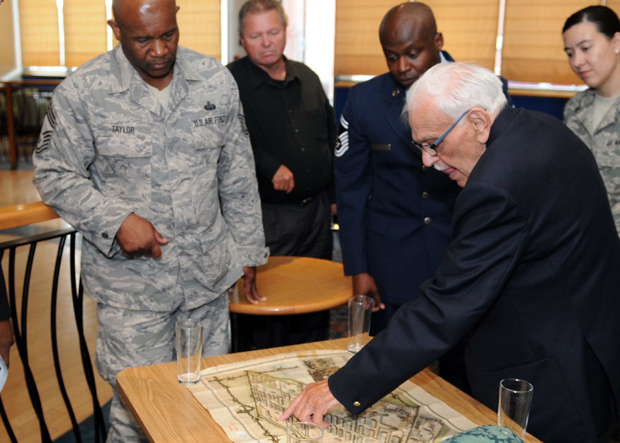 RAF MILDENHALL, England – Arther Edgley, a World War II prisoner of war, shows a map of the POW camp where he was held from 1943 to 1945, here Sept. 14, 2011.  Edgley met with base members after the POW/Missing in Action Remembrance Luncheon to answer questions about his time spent in captivity.  (U.S. Air Force photo by Staff Sgt. Tabitha M. Lee)