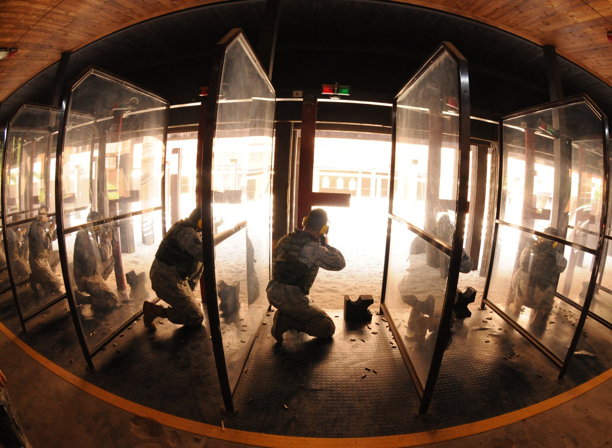 Airmen fire an M-4 assault rifle Sept. 13 at the Aviano Air Base, Italy, firing range. To qualify, Airmen must complete combat arms training and successfully hit 25 out of 50 targets. (U.S. Air Force photo/Airman 1st Class Jenay Randolph)