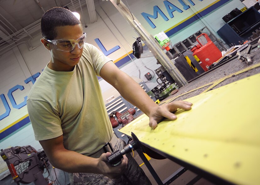 Airman Denzel Paylor, 22nd Maintenance Squadron aircraft structural maintenance journeyman, sands the final trimming on a KC-135 Stratotanker flap panel at the structural maintenance back shop Aug. 24, 2011, McConnell Air Force Base, Kan.  The Airmen sanded the $3,000 part to match the original flap panel.  Aircraft structural maintenance Airmen repair, inspect and replace plastic, fiberglass, bonded structures and bonded honeycomb aircraft components.  (U.S. Air Force photo by Senior Airman Maria A. Ruiz)