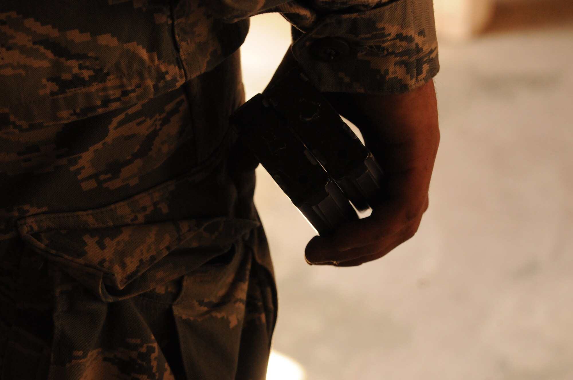 An Airman carries two M-4 assault rifle magazines Sept. 13 at the Aviano Air Base, Italy, firing range. In combat arms training, Airmen learn how to take apart and properly clean their weapon.  (U.S. Air Force photo/Airman 1st Class Jenay Randolph) 