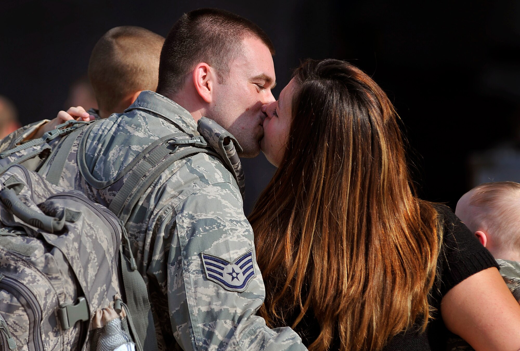 U.S. Air Force Staff Sgt. Dustin Brewer, 77th Fighter Squadron, crew chief gets a welcome home kiss from his wife Molley Brewer as he returns home from a five month deployment in support of Operation Unified Protector, Shaw Air Force Base, S.C. Sept. 14, 2011. The mission of the 77th FS crew chiefs and maintainers was to support 77th FS pilots as they provided air suppression and destruction of enemy defenses. (U.S. Air Force photo by Senior Airman Kenny Holston/Released)


