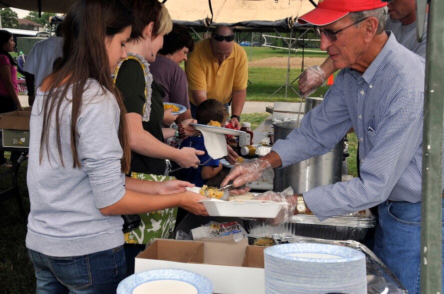 Volunteers serve lunch to reservists and their families during the 442nd Fighter Wing Family Day picnic, Sept. 10, 2011. The lunch, free to Airmen and their families, included steak, potatoes and corn. The 442nd FW is an A-10 Thunderbolt II Air Force Reserve unit at Whiteman AIr Force Base, Mo. (U.S. Air Force photo/ Senior Airman Wesley Wright)